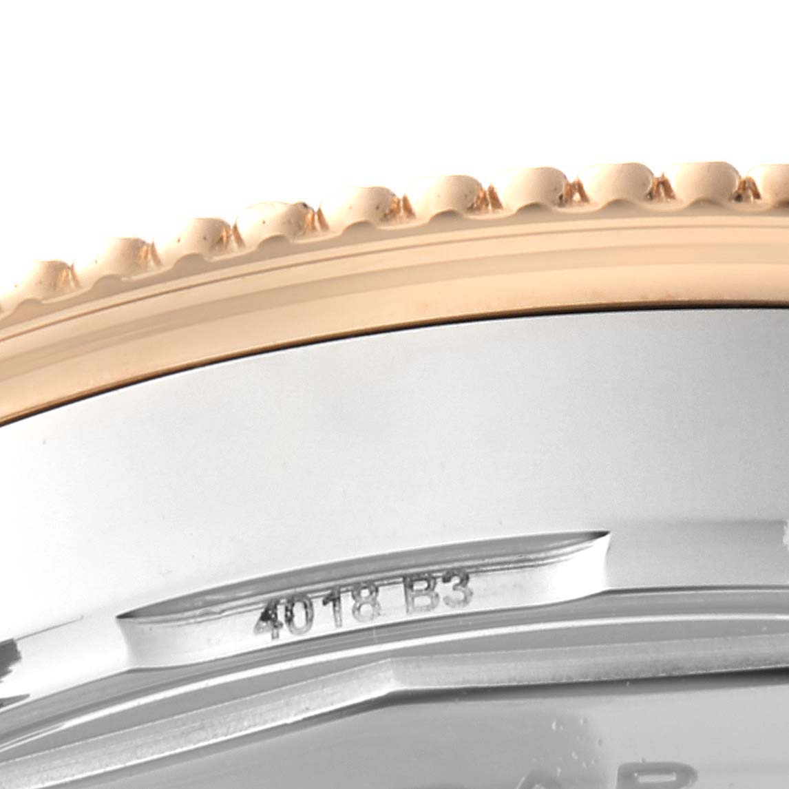 The image shows an angled close-up of the bezel and case side of a Breitling Navitimer U17325211G1A1 Men's Stainless Steel Silver Dial U17325211G1A1 Men's Stainless Steel Silver Dial watch, highlighting the serial number.