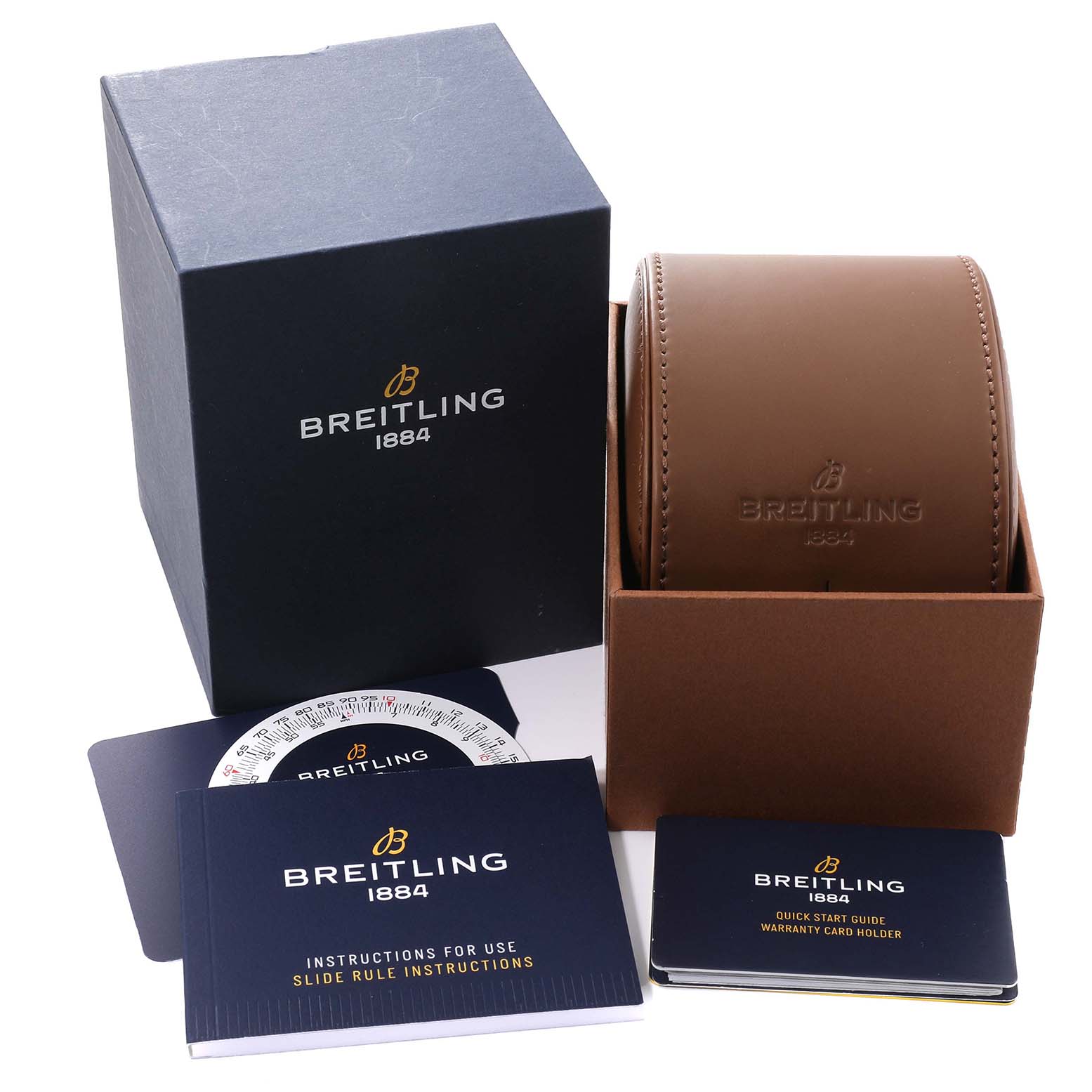 The image shows the packaging and accessories of a Breitling Navitimer A17326 Men's Stainless Steel Black Dial A17326 Men's Stainless Steel Black Dial, including a brown leather case, warranty cardholder, and instruction manuals.