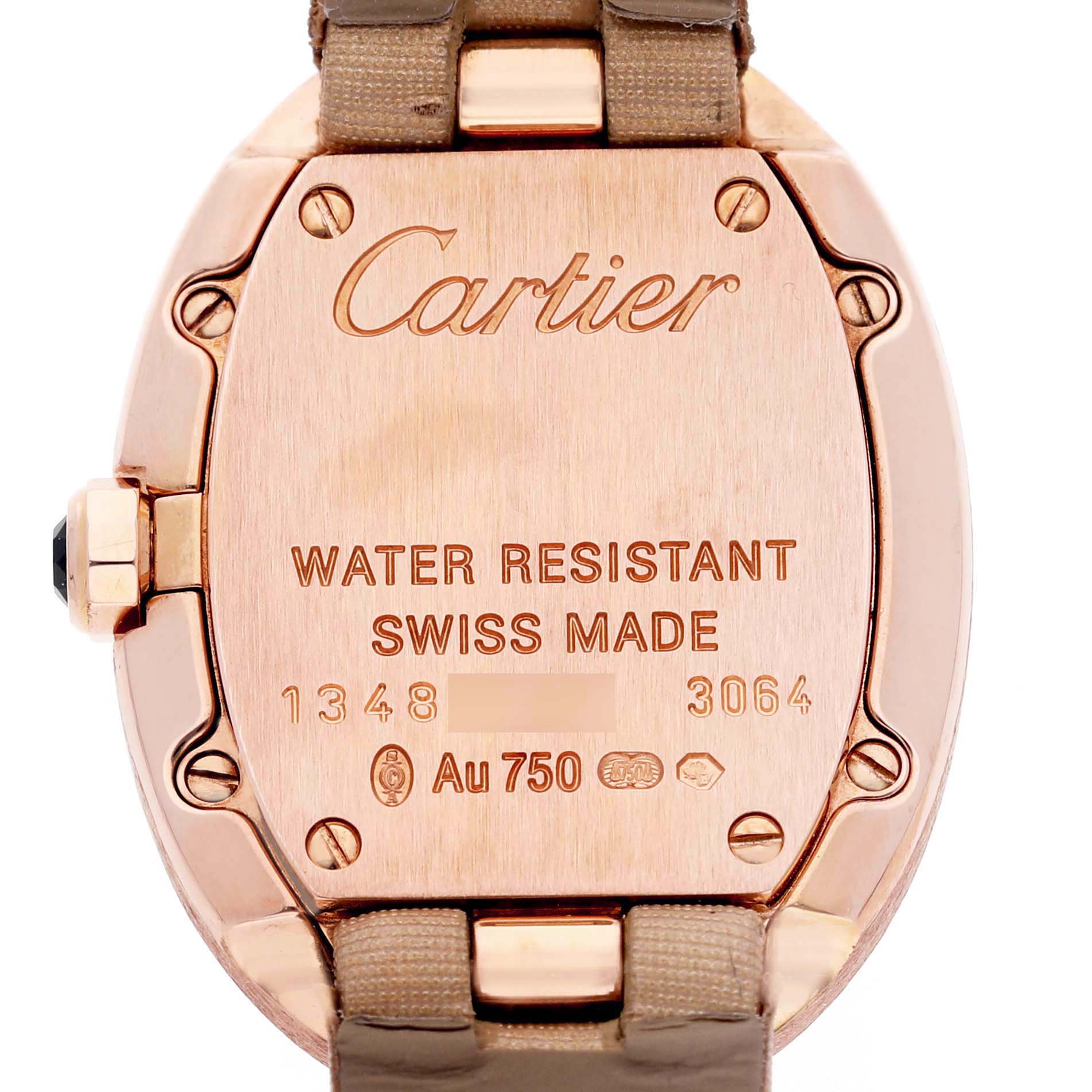 The image shows the back case of a Cartier Baignoire W8000007 Women's Yellow Gold Silver Dial watch, featuring engravings and part of the strap.
