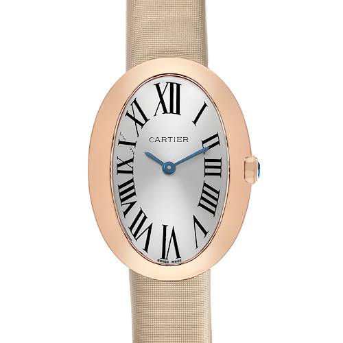 The Cartier Baignoire W8000007 Women's Yellow Gold Silver Dial watch is shown from a front angle, displaying its oval case, Roman numerals, blue hands, and beige strap.