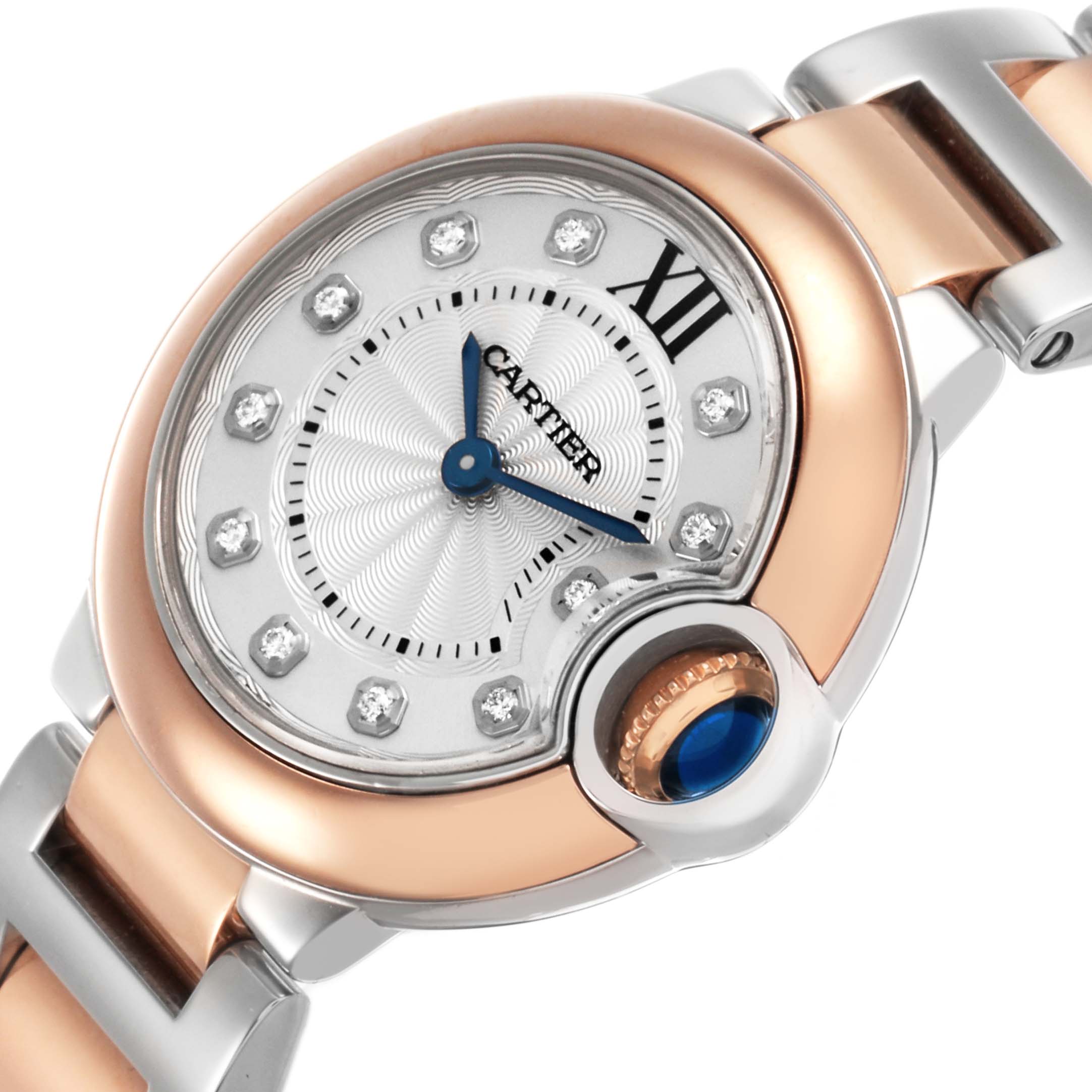 The Ballon Bleu by Cartier is shown at a close angle, highlighting the watch face, bezel, and partial bracelet.