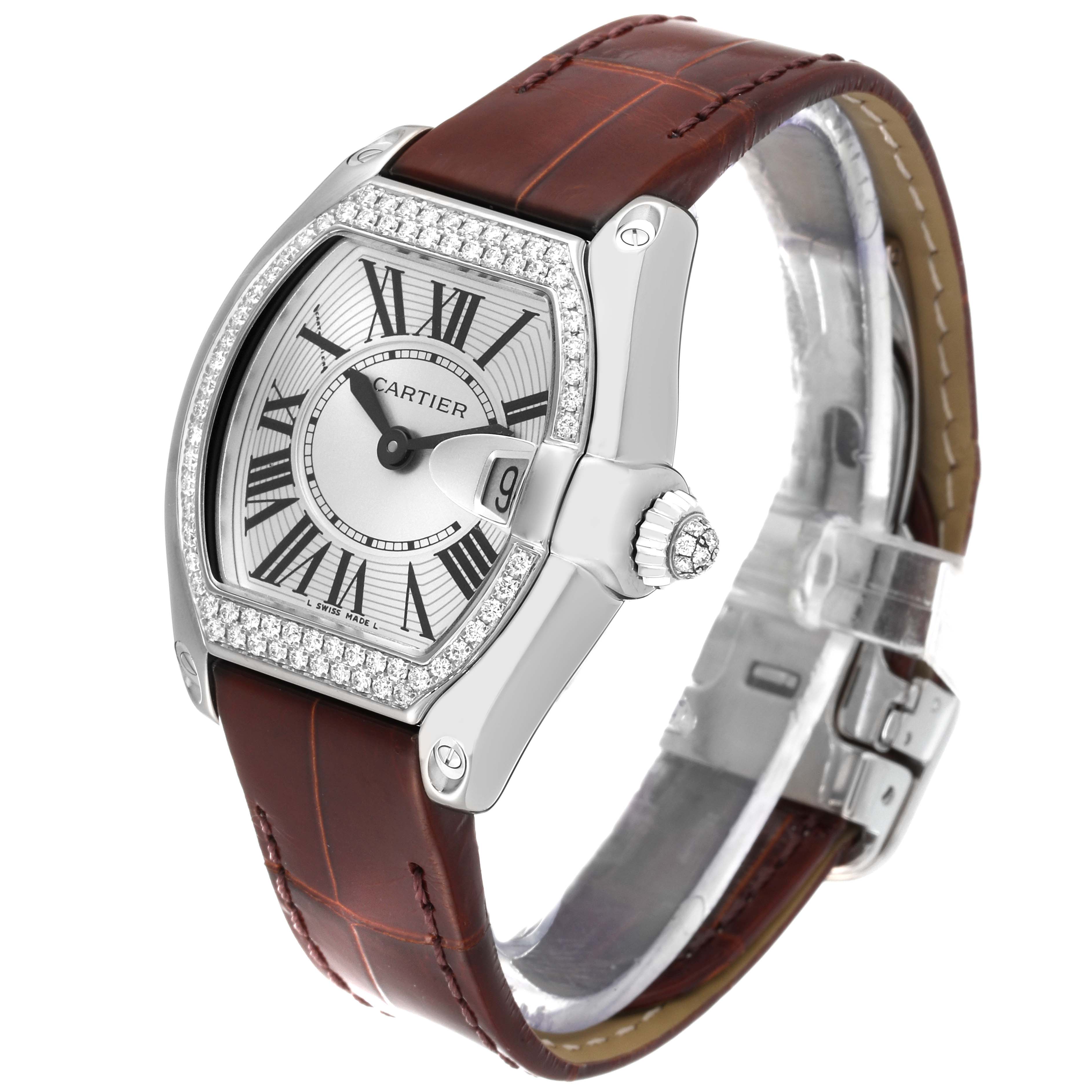 The Cartier Roadster WE500260 Women's White Gold Silver Dial WE500260 Women's White Gold Silver Dial watch is shown at a slight angle, revealing the dial, case, bezel, crown, and leather strap.