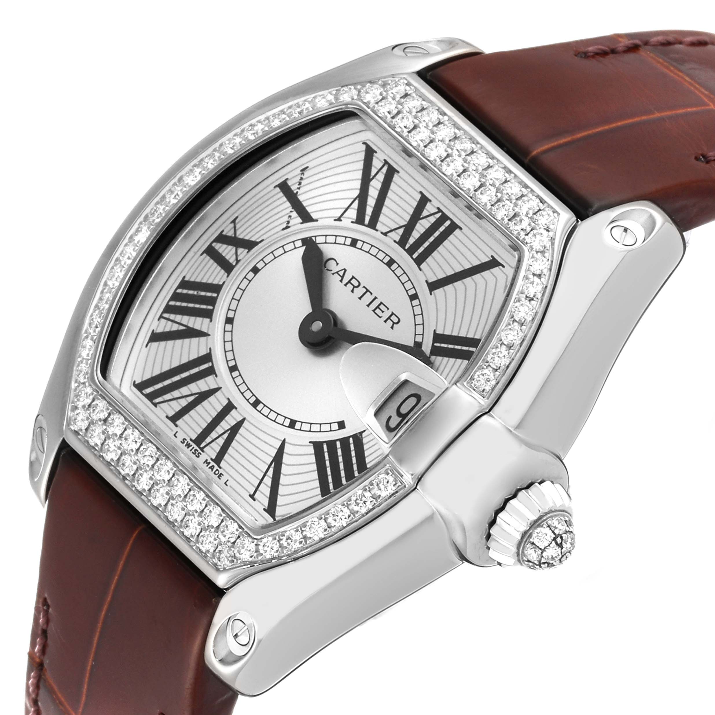 The Cartier Roadster WE500260 Women's White Gold Silver Dial WE500260 Women's White Gold Silver Dial watch is shown at an angle, displaying its dial, bezel, casing, crown, and leather strap.