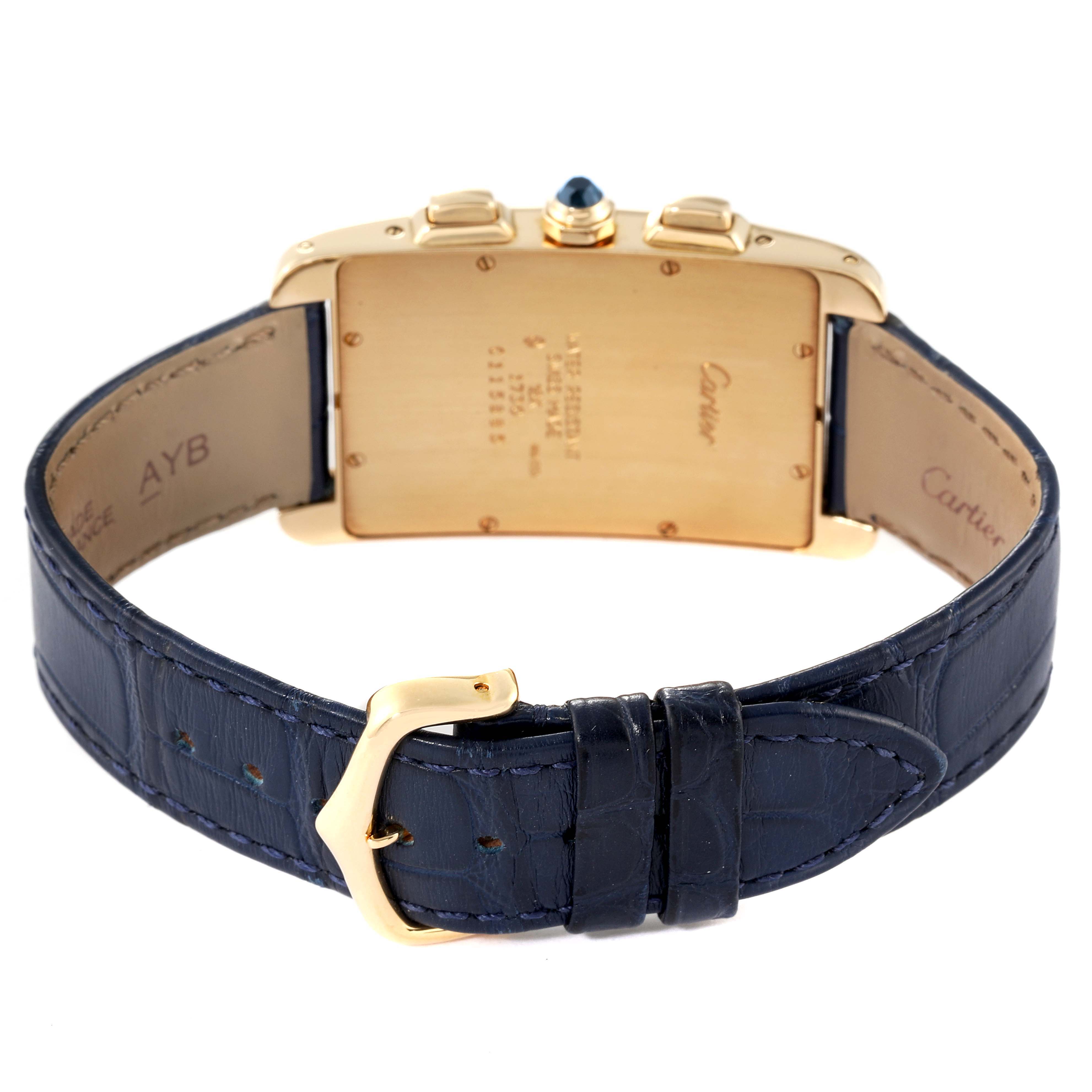 The image shows the back of the Cartier Tank Americaine W2601156 Men's Yellow Gold Silver Dial W2601156 Men's Yellow Gold Silver Dial watch, highlighting its gold case and blue leather strap with a buckle.