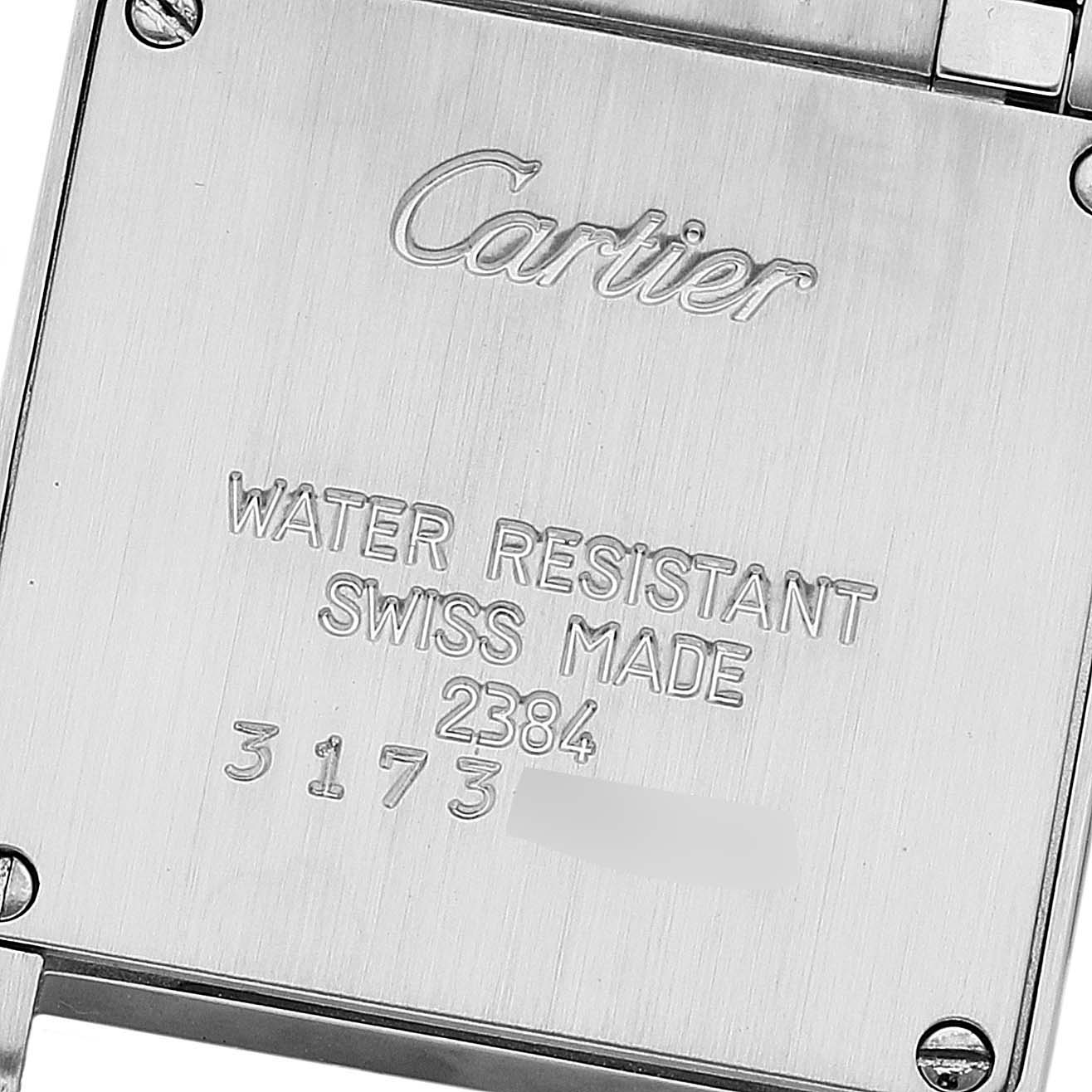 This image shows the back case of a Cartier Tank Française watch, highlighting the engraved brand details and serial numbers.