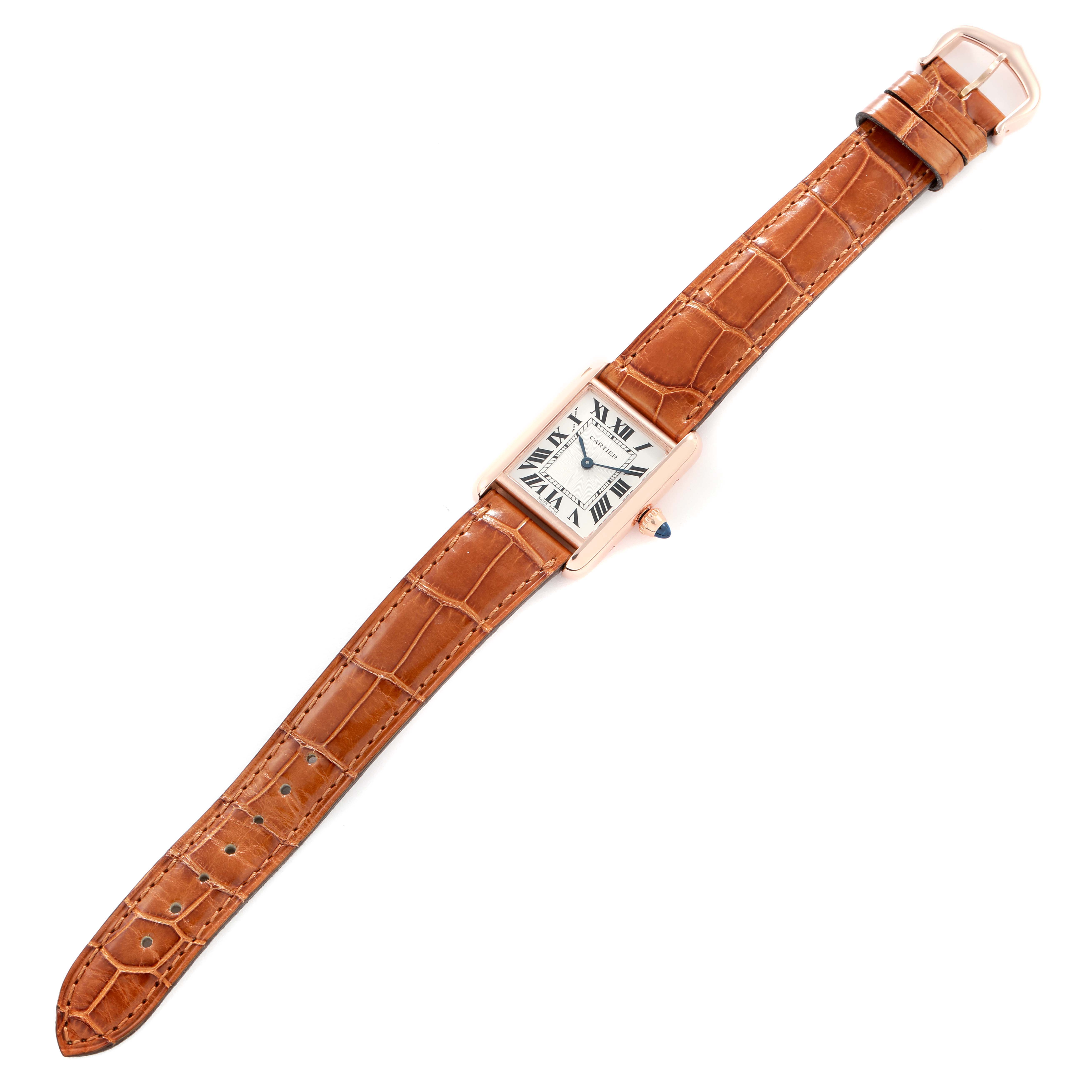 The Cartier Tank Louis WGTA0010 Women
s Rose Gold Silver Dial watch is shown from a top-down angle, highlighting its leather strap and rectangular face.