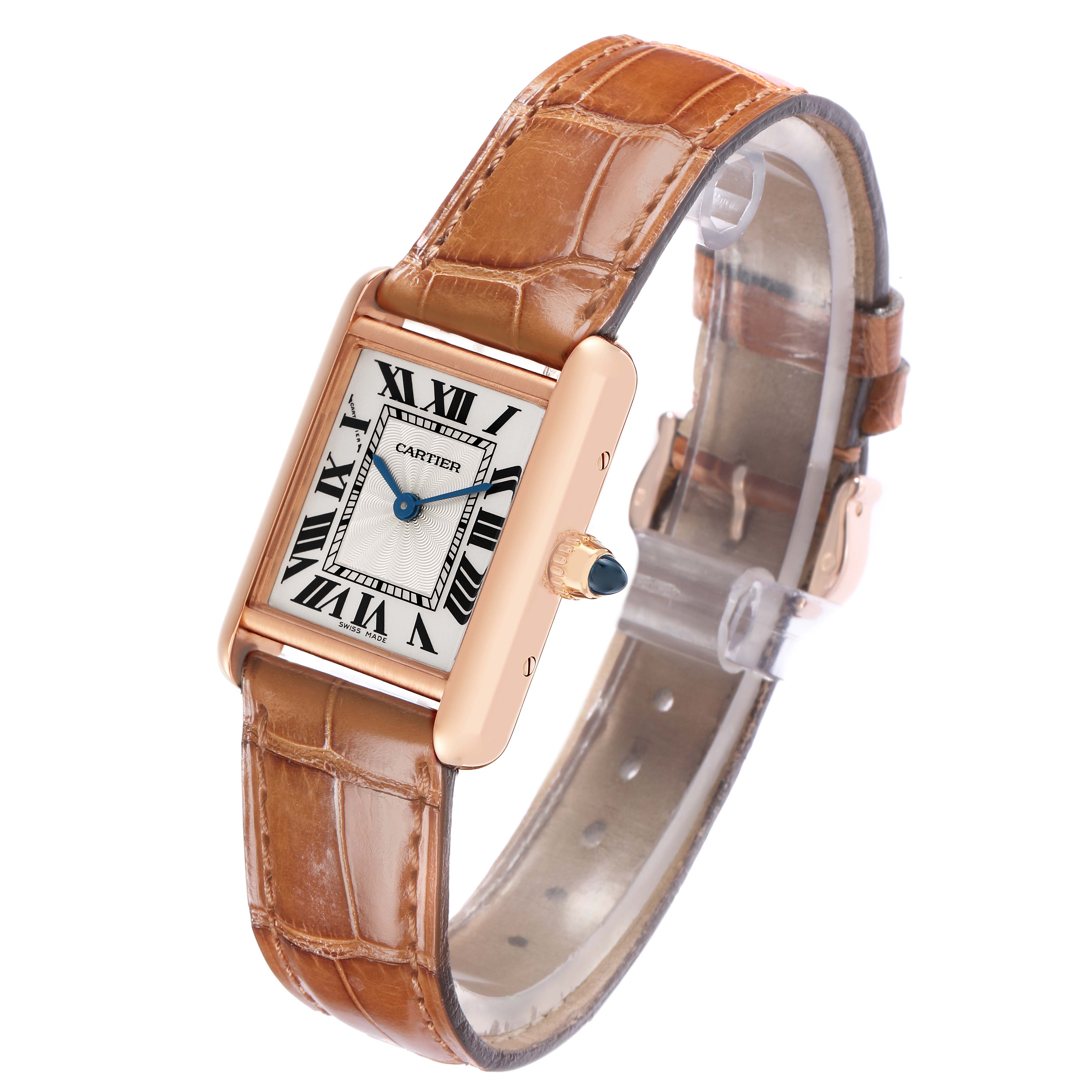 The Cartier Tank Louis WGTA0010 Women
s Rose Gold Silver Dial watch is shown at a slight angle, displaying the face, strap, and crown with a blue cabochon.