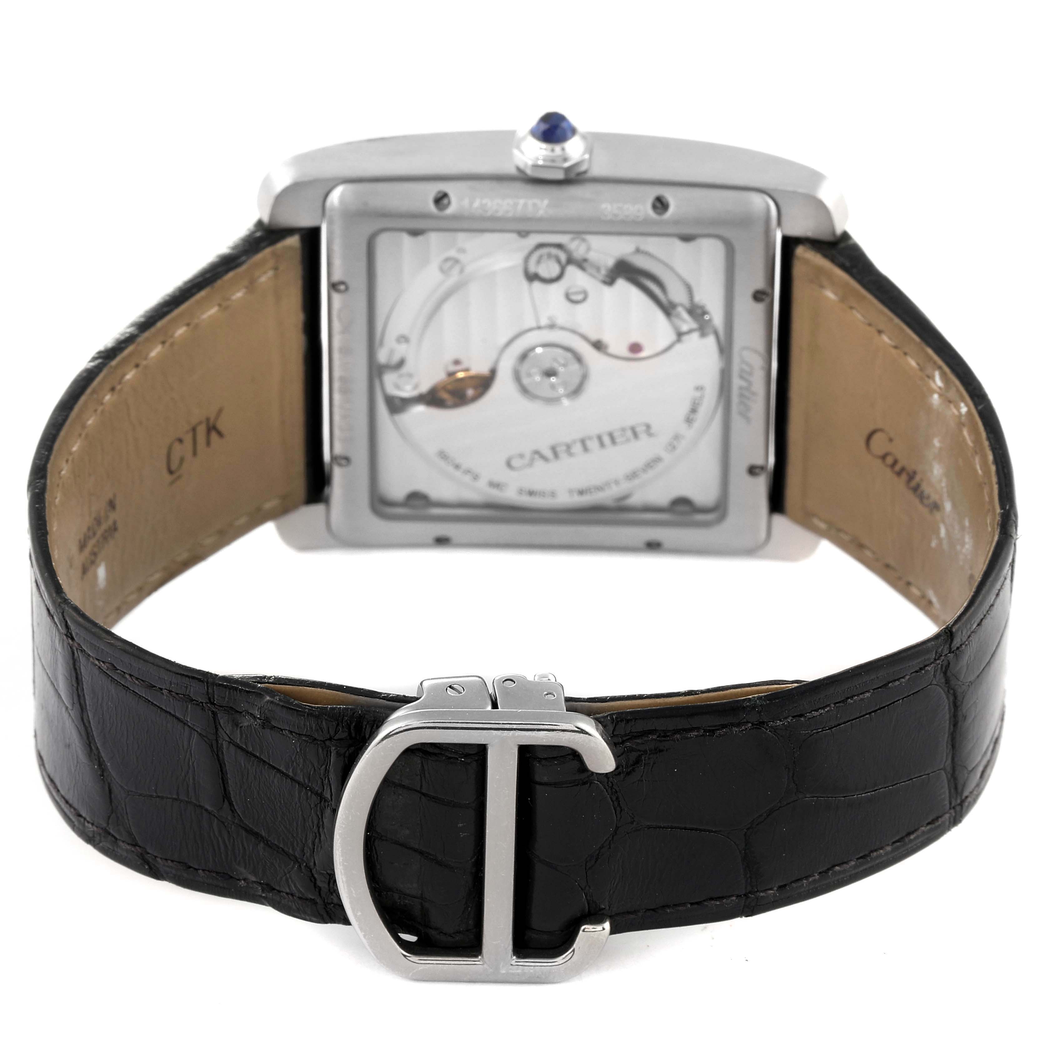 The image shows the back view of the Cartier Tank MC W5330003 Men's Stainless Steel Silver Dial W5330003 Men's Stainless Steel Silver Dial watch, highlighting its movement, leather strap, and deployant clasp.