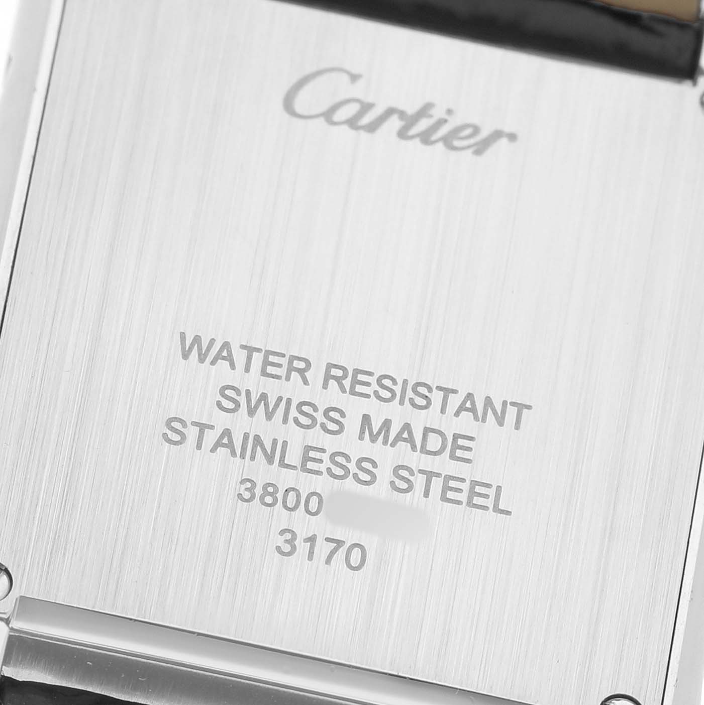 The image shows the back of a Cartier Tank Solo WSTA0030 Women's Stainless Steel Silver Dial watch, highlighting its branding and specifications.