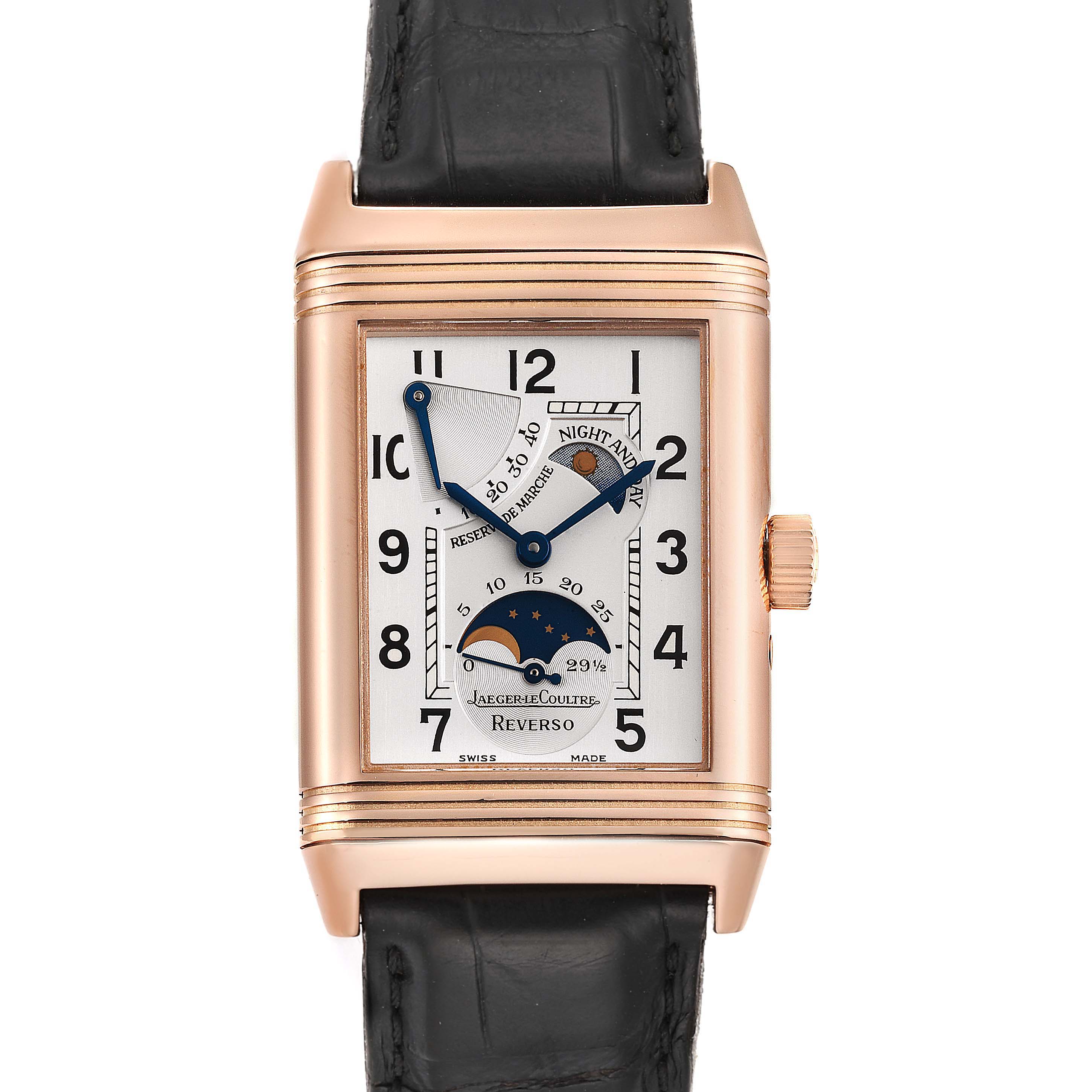 The image shows a frontal view of a Jaeger LeCoultre Reverso Q3042420 Men
s Rose Gold Silver Dial Q3042420 Men
s Rose Gold Silver Dial watch, highlighting its rectangular dial, moon phase, and reserve de marche indicators.