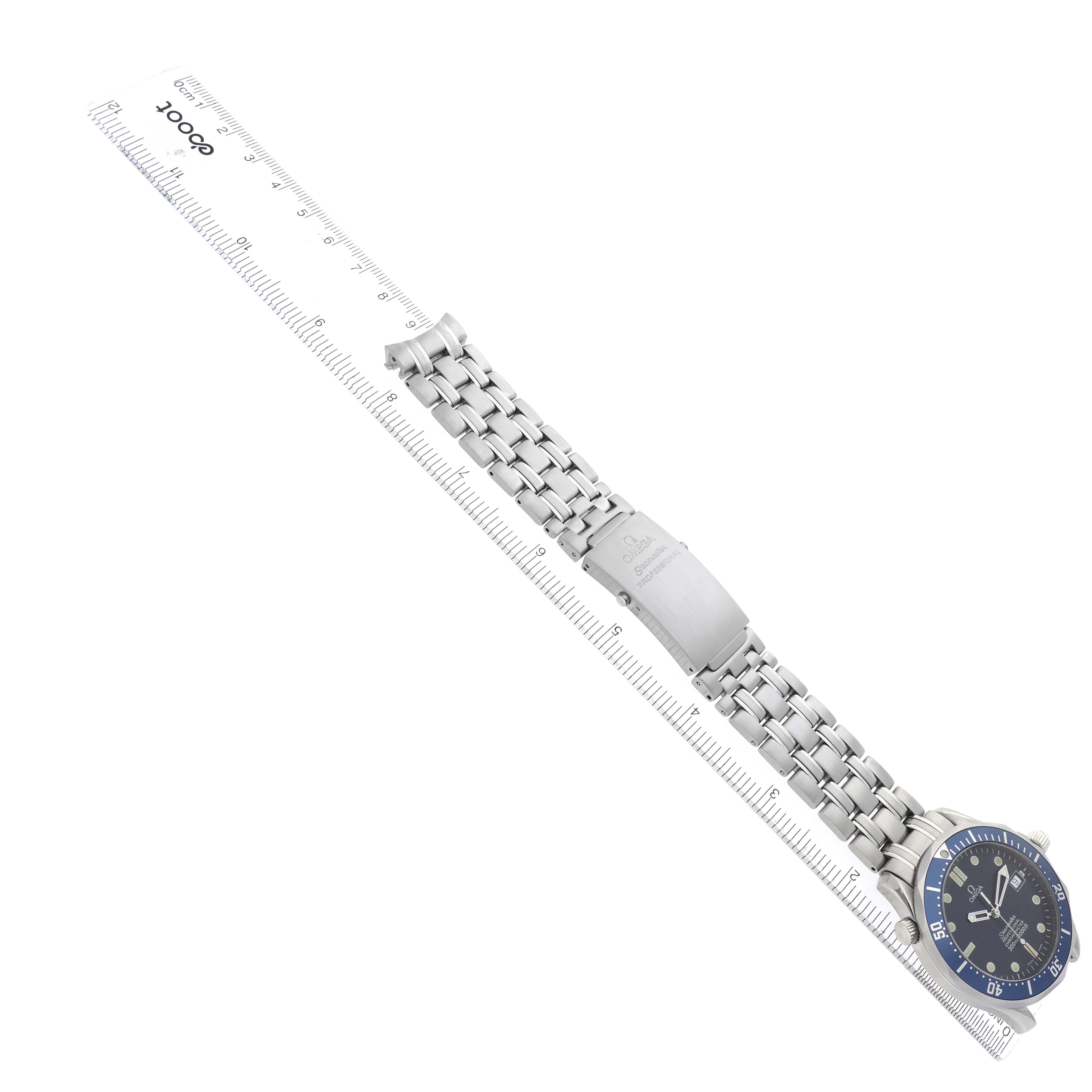 The Omega Seamaster 2531.80.00 Men
s Stainless Steel Blue Dial watch is shown at an angle, displaying the face, bracelet, and clasp next to a ruler.