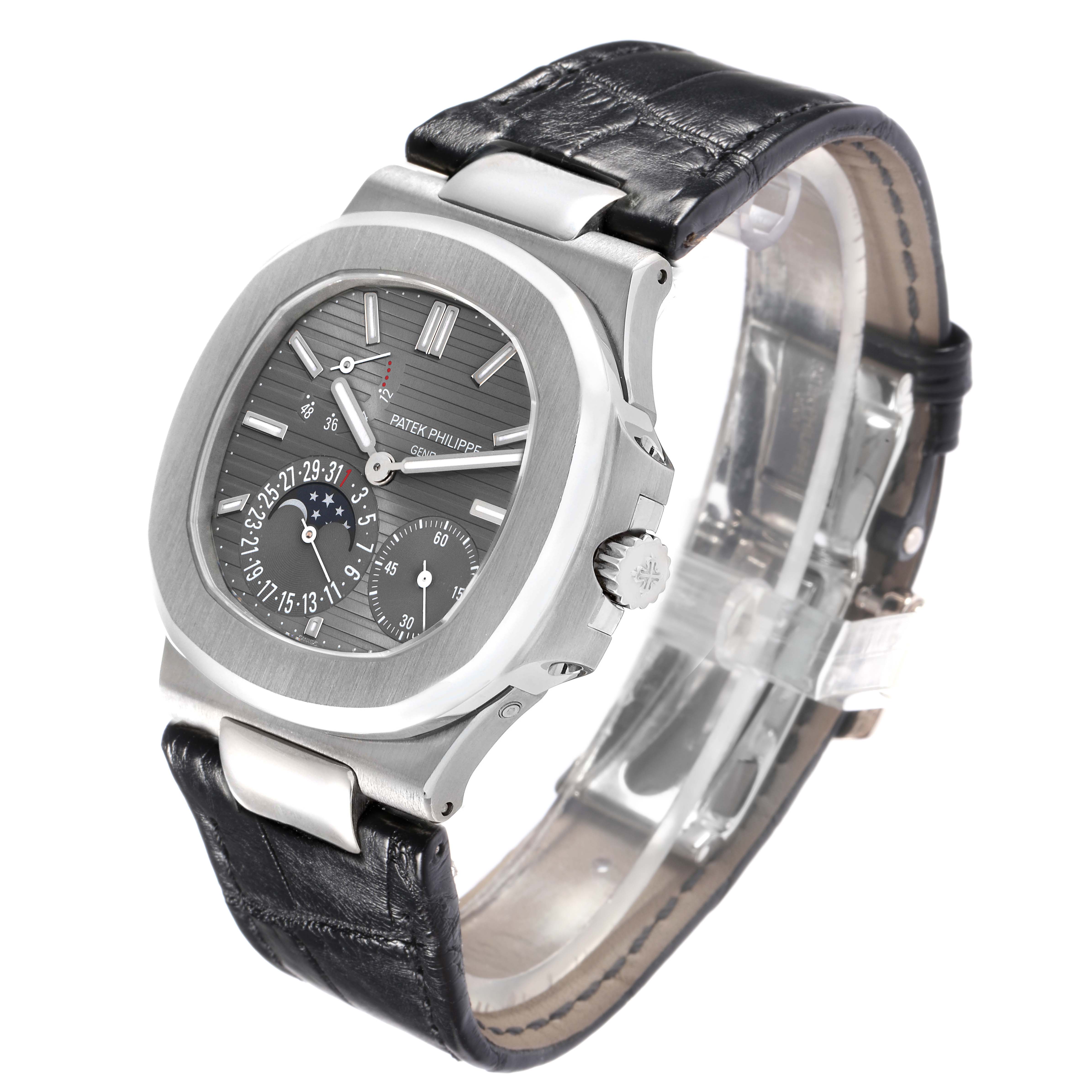 The Patek Philippe Nautilus 5712G Men
s White Gold Grey Dial watch is shown at a slightly tilted angle, highlighting the dial, case, and part of the black leather strap.