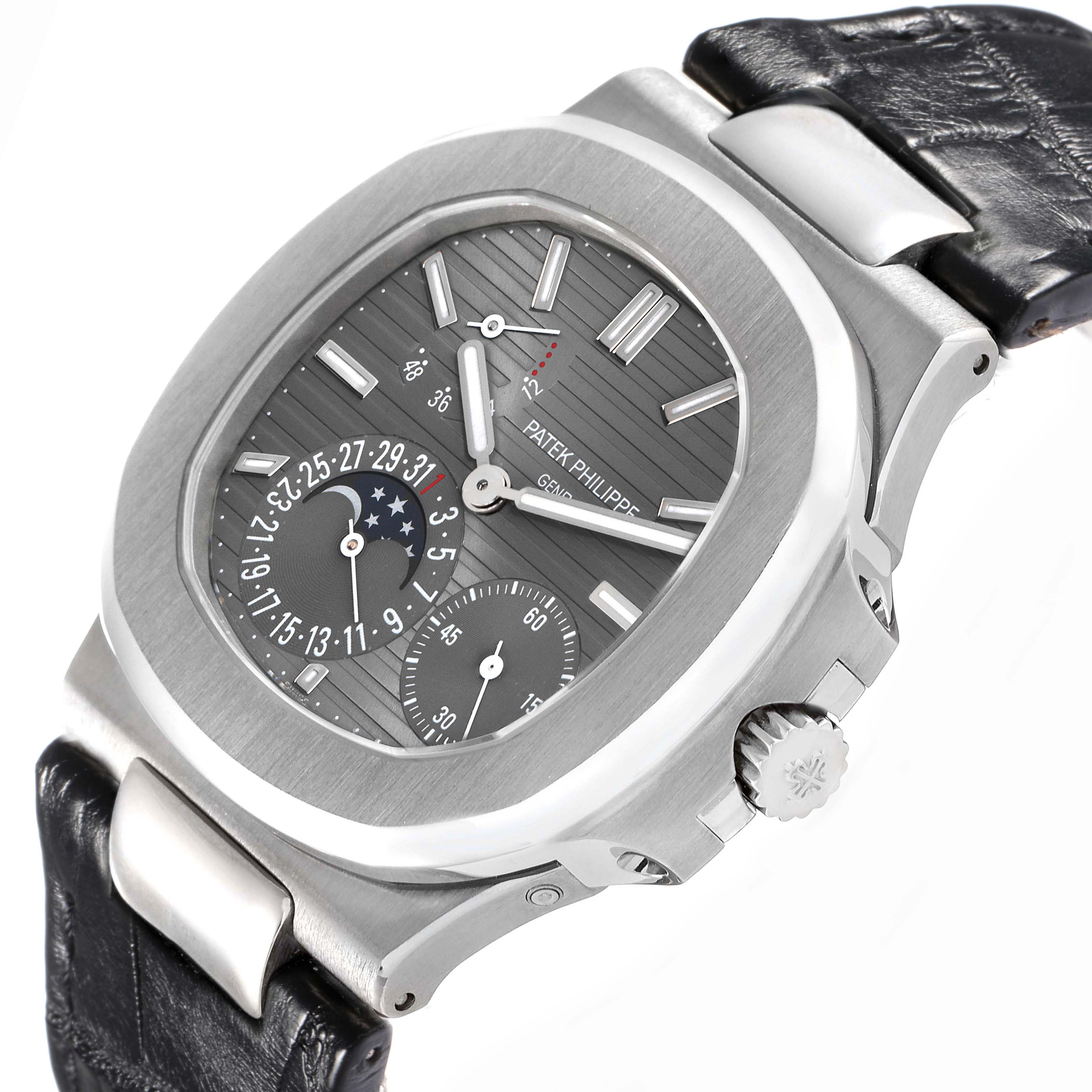 The Patek Philippe Nautilus 5712G Men
s White Gold Grey Dial watch is shown at a diagonal angle, highlighting the dial, crown, and part of the leather strap.