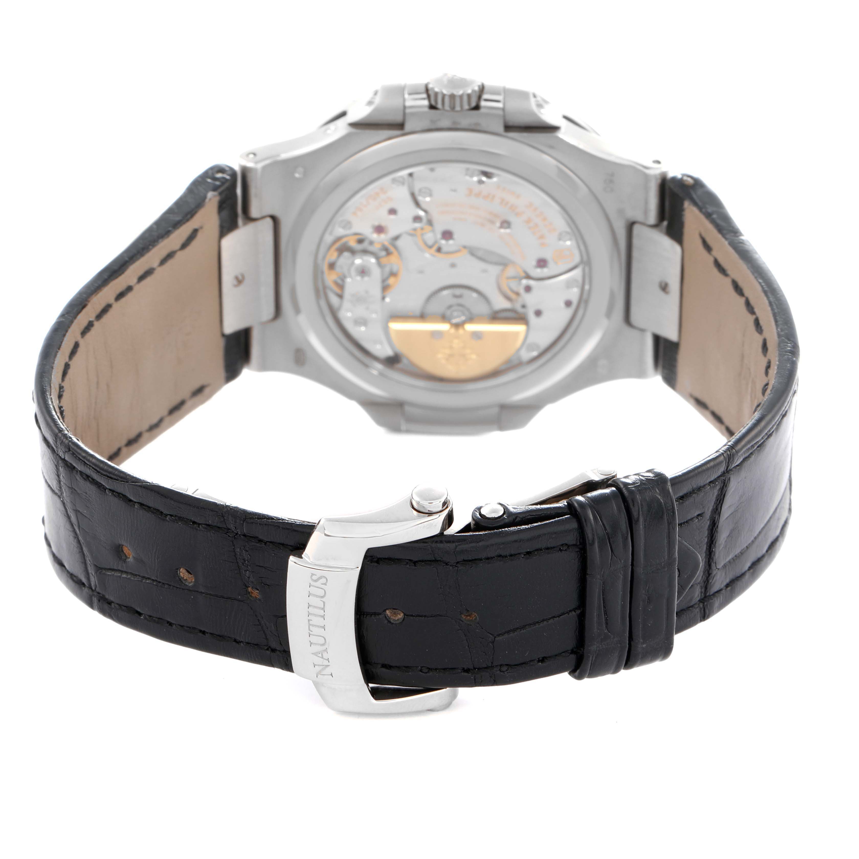The image shows the back view of a Patek Philippe Nautilus 5712G Men
s White Gold Grey Dial watch, highlighting its transparent case back and leather strap.