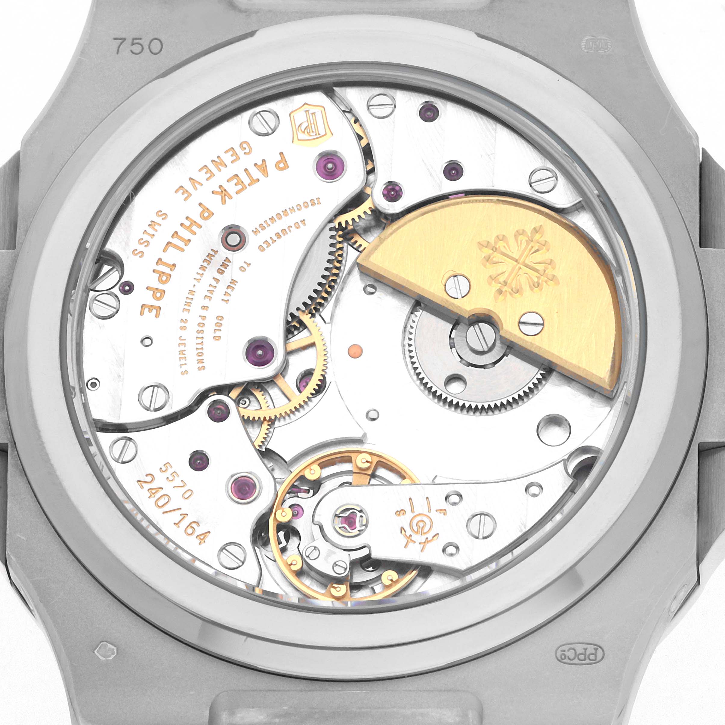 The image shows the back view of a Patek Philippe Nautilus 5712G Men
s White Gold Grey Dial, highlighting its movement and components like the rotor and gears.