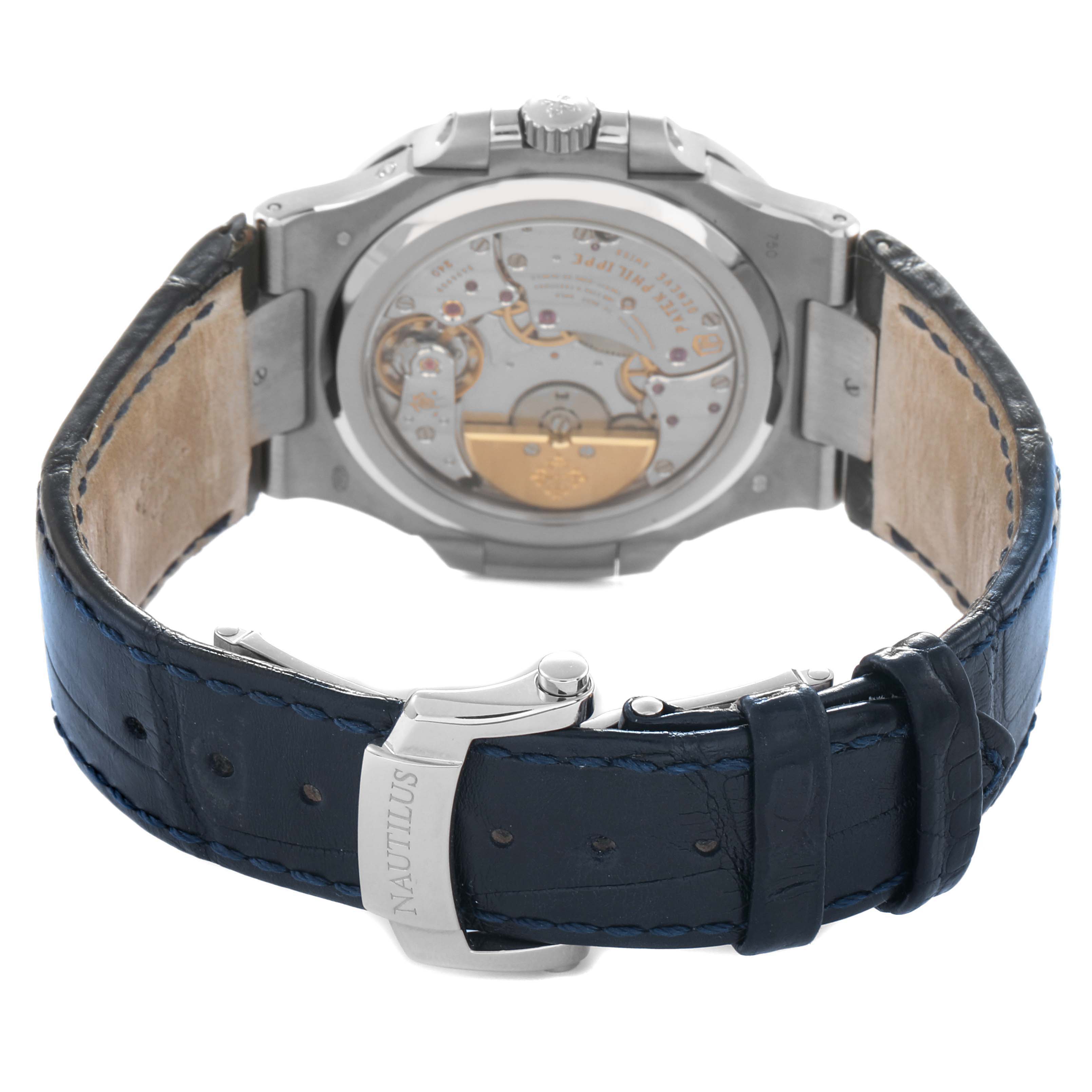 The image shows the back of a Patek Philippe Nautilus 5712G Men's White Gold Grey Dial watch, displaying its movement and leather strap with clasp.