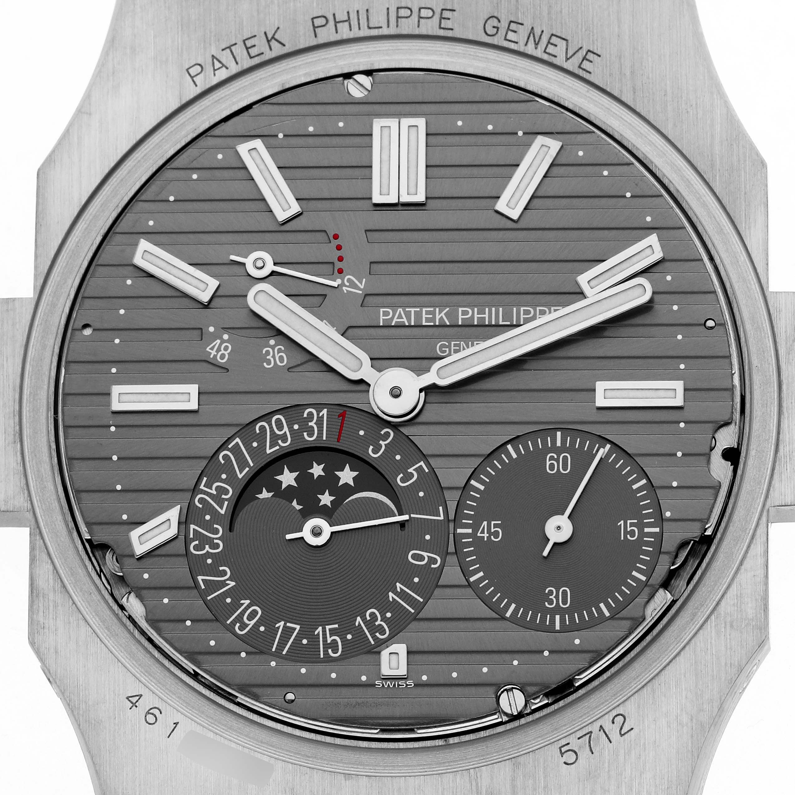 This image shows a close-up of the Patek Philippe Nautilus 5712G Men's White Gold Grey Dial 5712 watch dial, highlighting the time, date, moon phase, and power reserve.