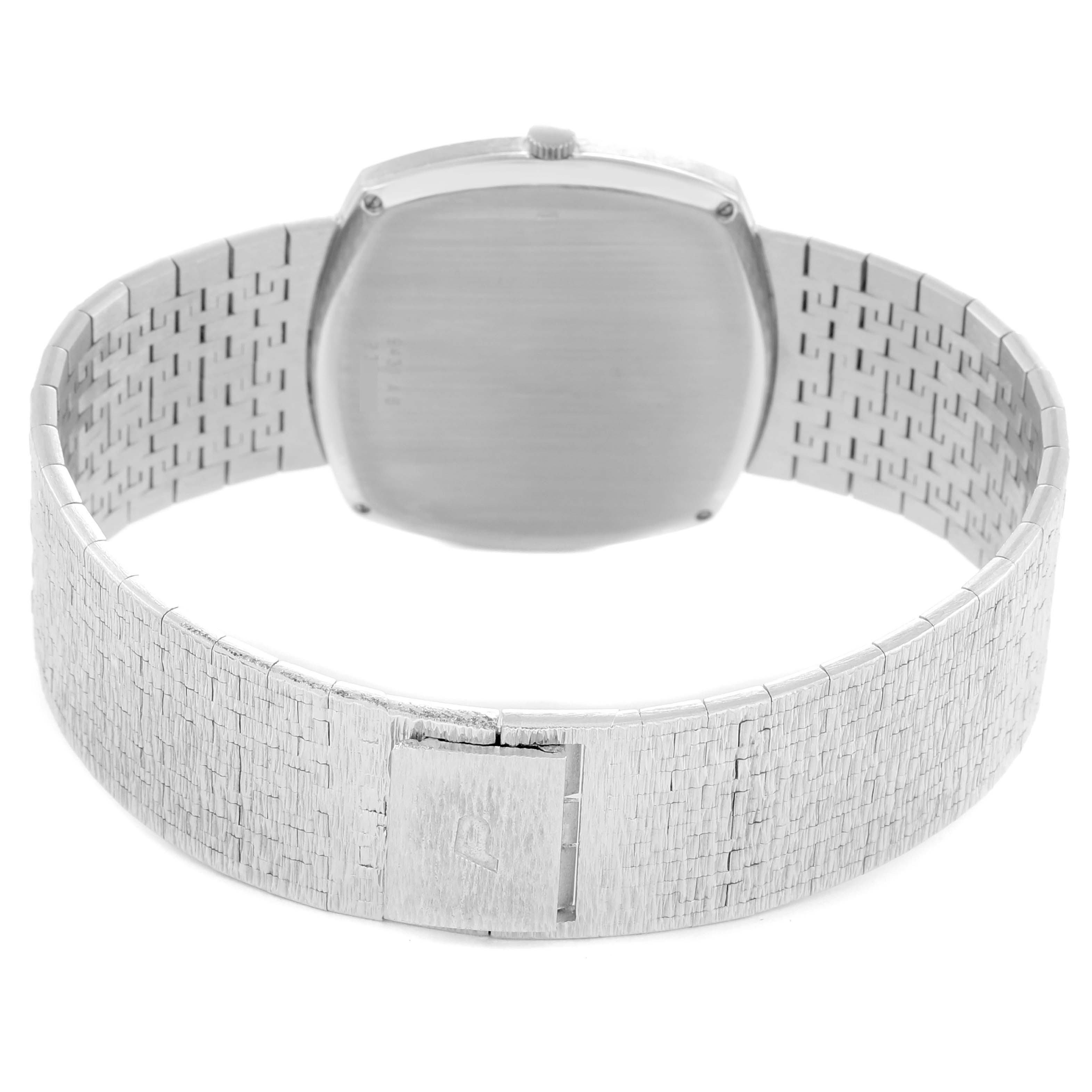 The image shows the back view of the Piaget 9431A6 Women
s White Gold Silver Dial 9431A6 watch, highlighting its clasp and patterned white gold bracelet.
