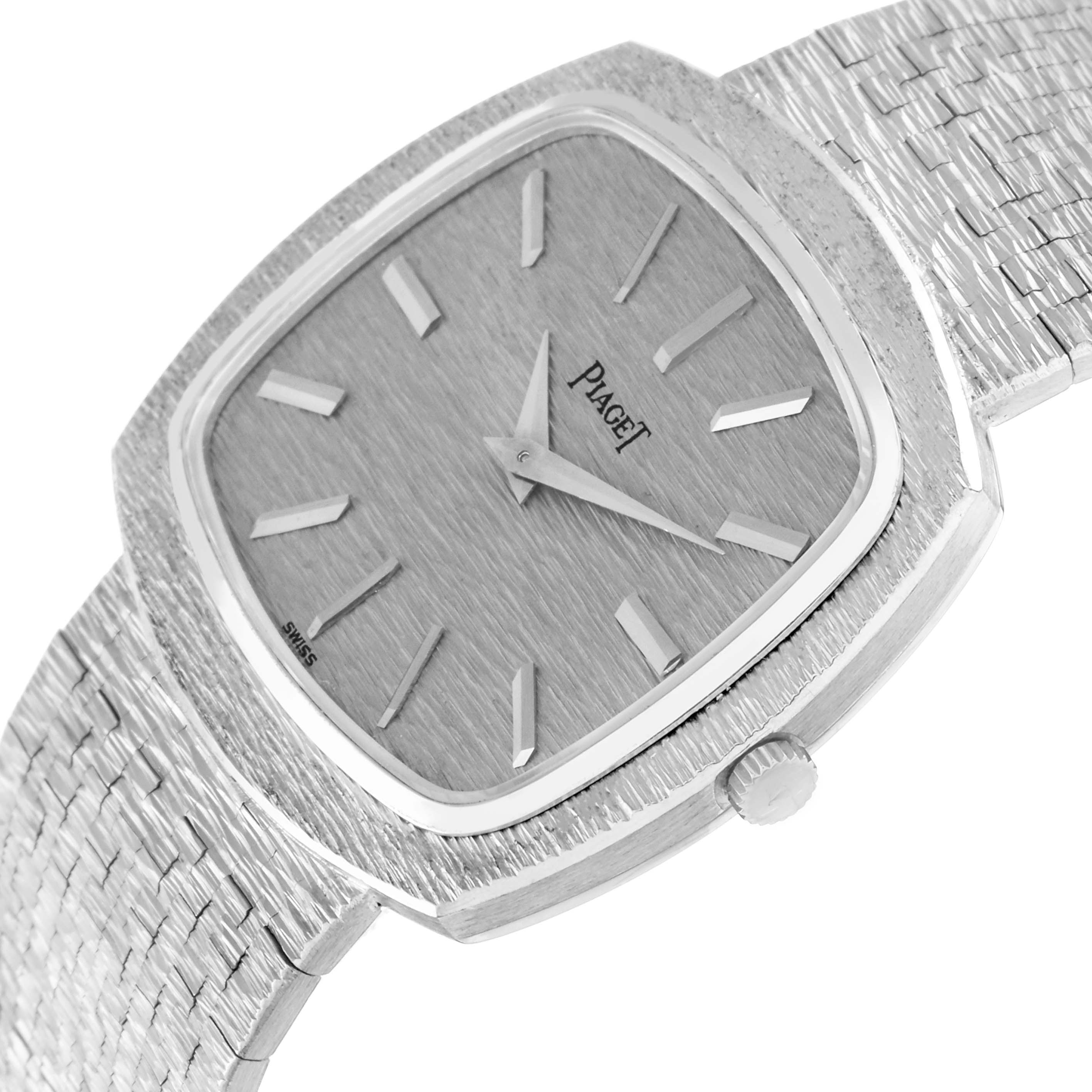 The Piaget 9431A6 Women
s White Gold Silver Dial 9431A6 watch is shown at an angle highlighting its white gold stepped bezel, textured dial, and crown.