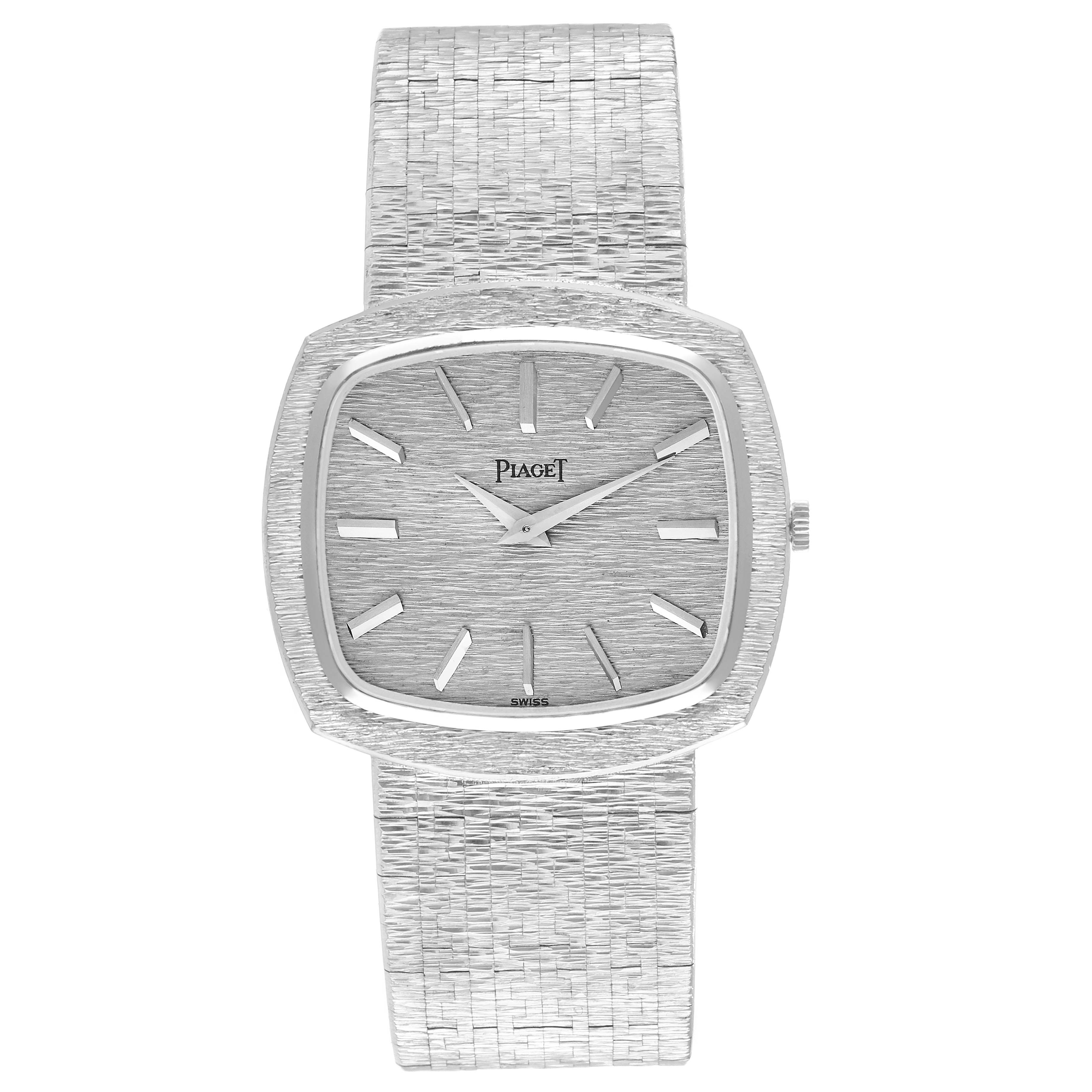 The Piaget 9431A6 Women
s White Gold Silver Dial 9431A6 watch is shown from a top view, displaying the dial, white gold stepped bezel, and textured bracelet.