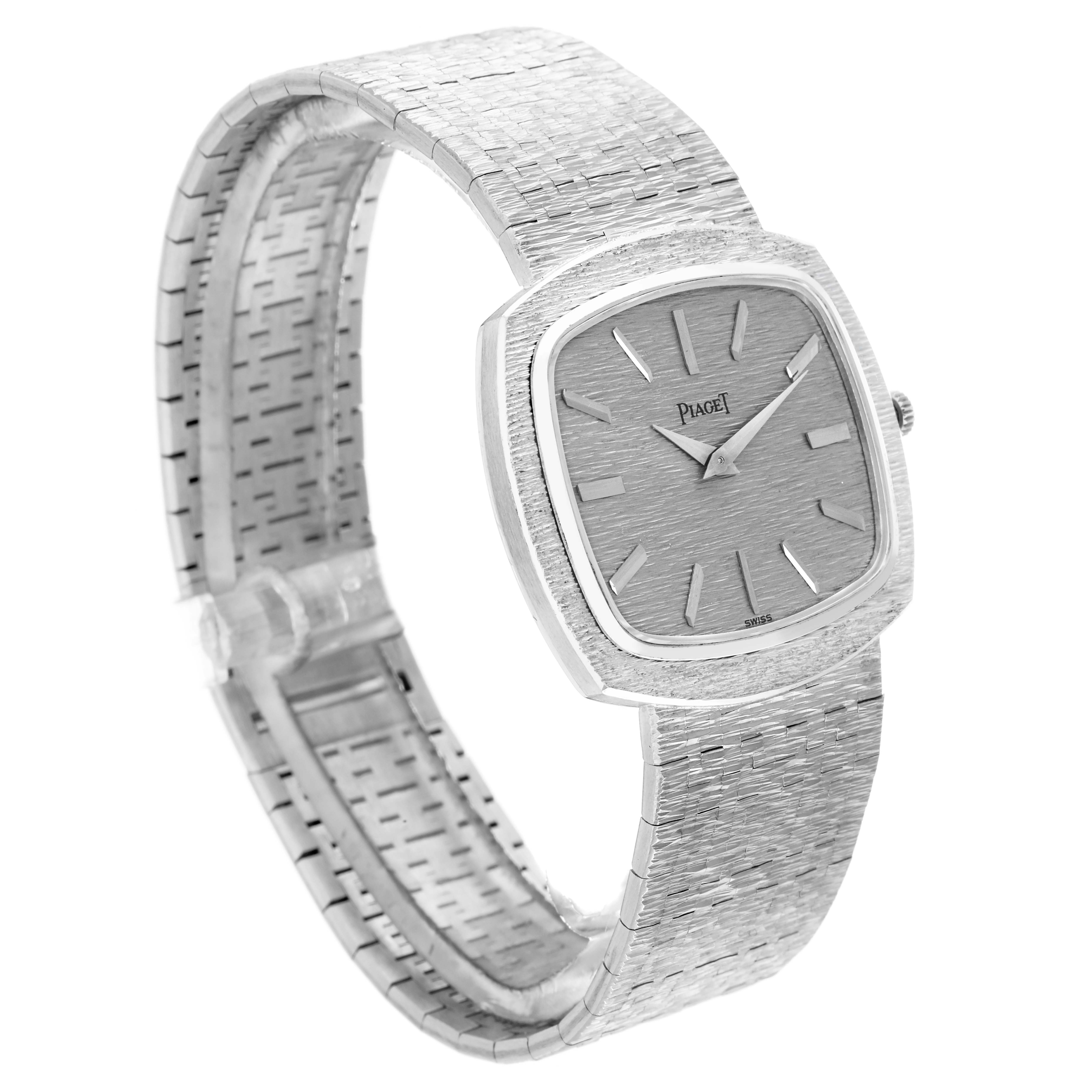 This Piaget 9431A6 Women
s White Gold Silver Dial 9431A6 model is shown at a slight angle, highlighting its white gold stepped bezel and textured bracelet.