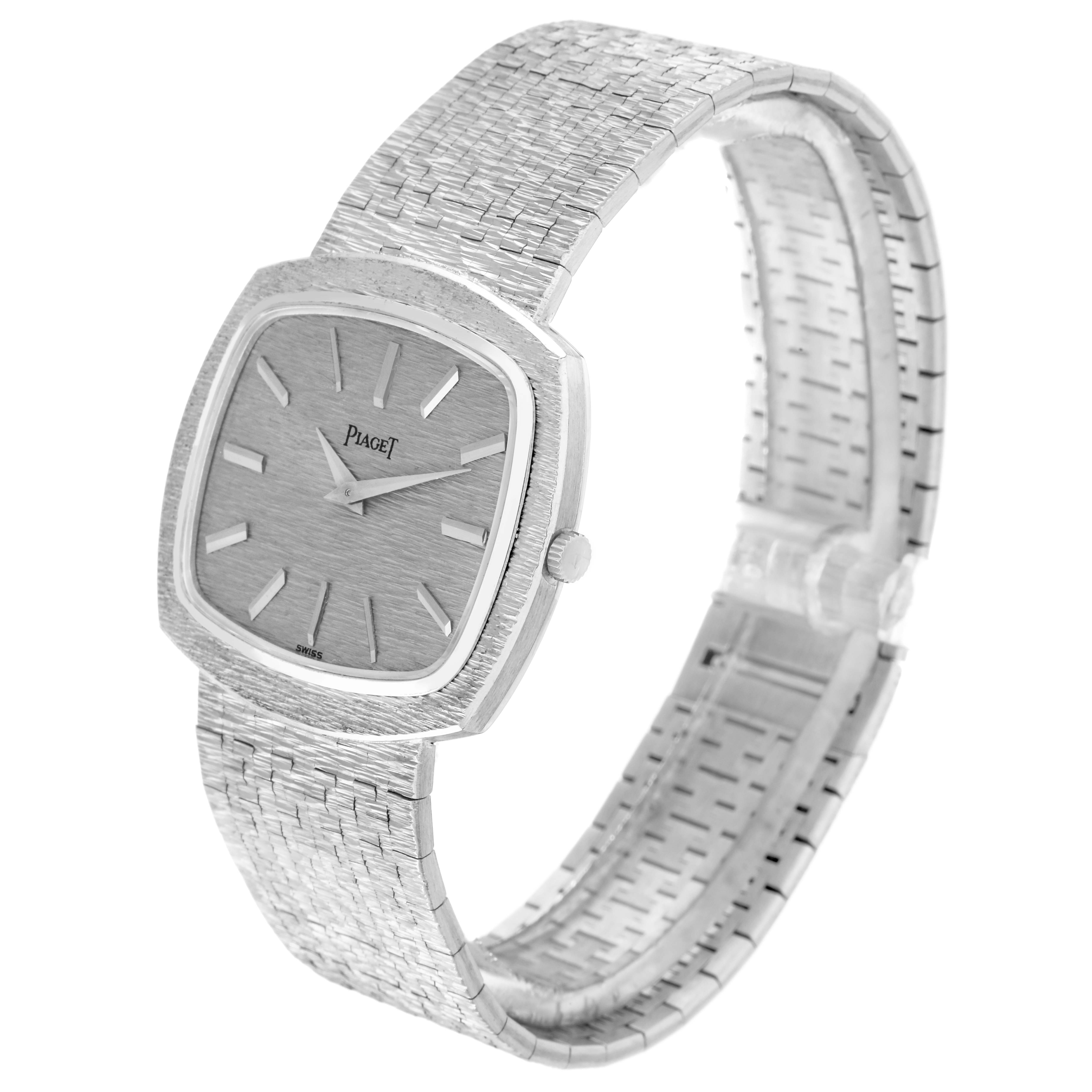 The Piaget 9431A6 Women
s White Gold Silver Dial 9431A6 watch is shown from a side angle, displaying its white gold stepped bezel and textured bracelet.
