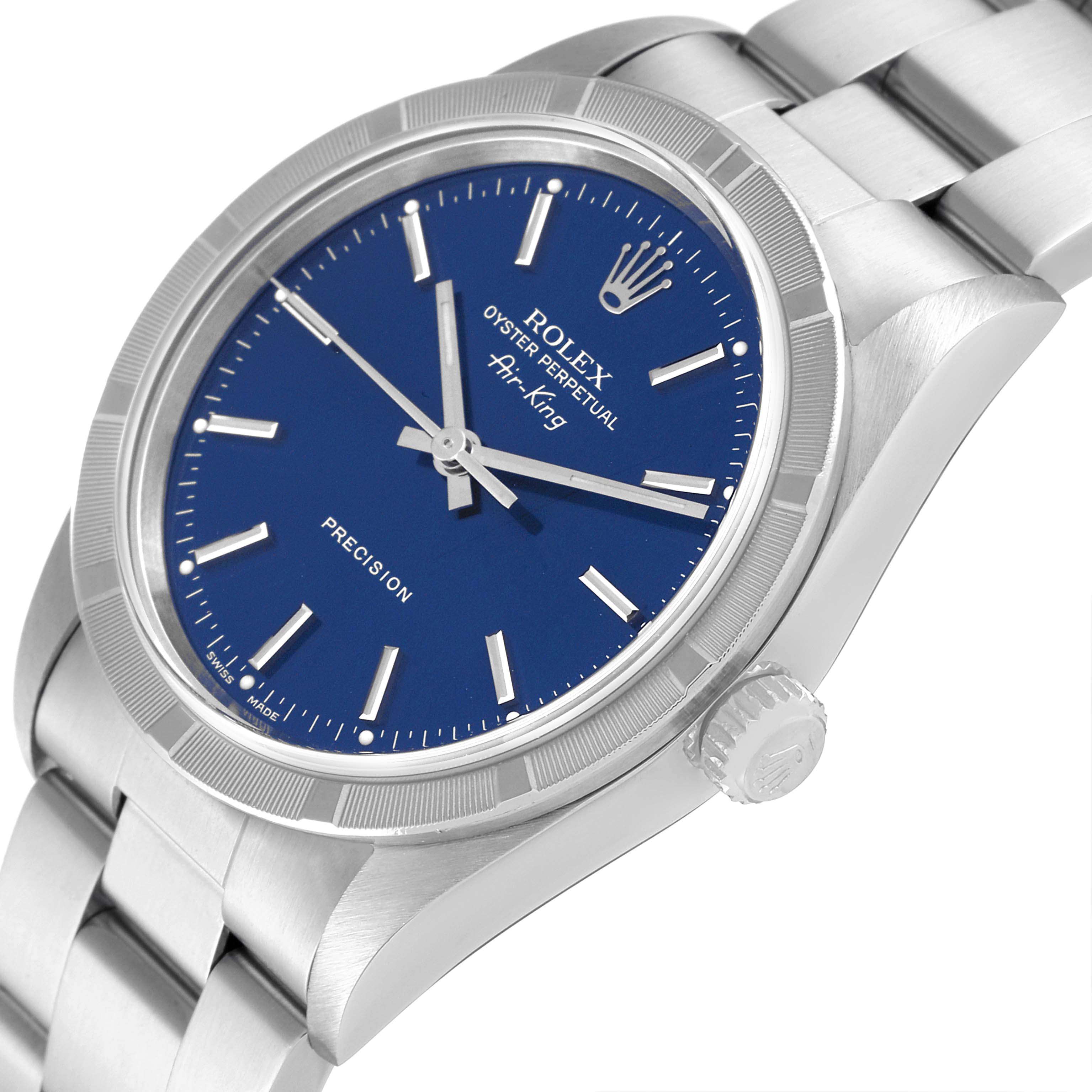 The image shows a close-up, side angle of the Rolex Air-King 14010 Men's Stainless Steel Blue Dial 14010 Men's Stainless Steel Blue Dial watch featuring its blue dial, silver markers, and part of the metal bracelet.