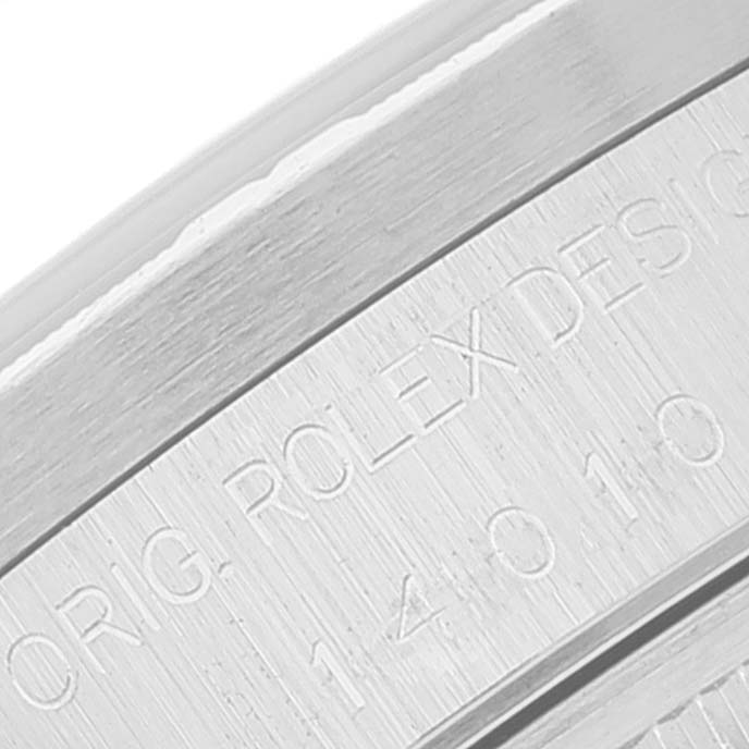 This image shows an angled close-up of the engraved bezel of a Rolex Air-King 14010 Men's Stainless Steel Blue Dial 14010 Men's Stainless Steel Blue Dial watch.