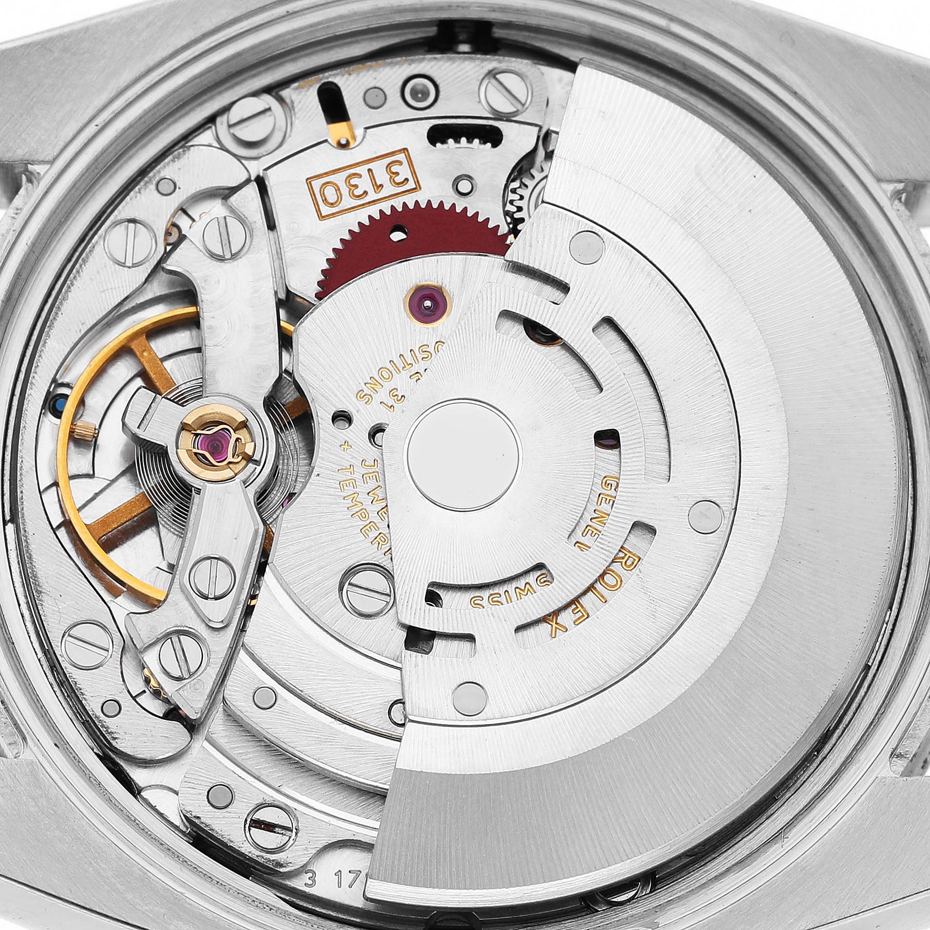 The image shows the intricate movement of a Rolex Air-King 114210 Men's Stainless Steel Pink Dial watch from the back, highlighting its mechanical components.