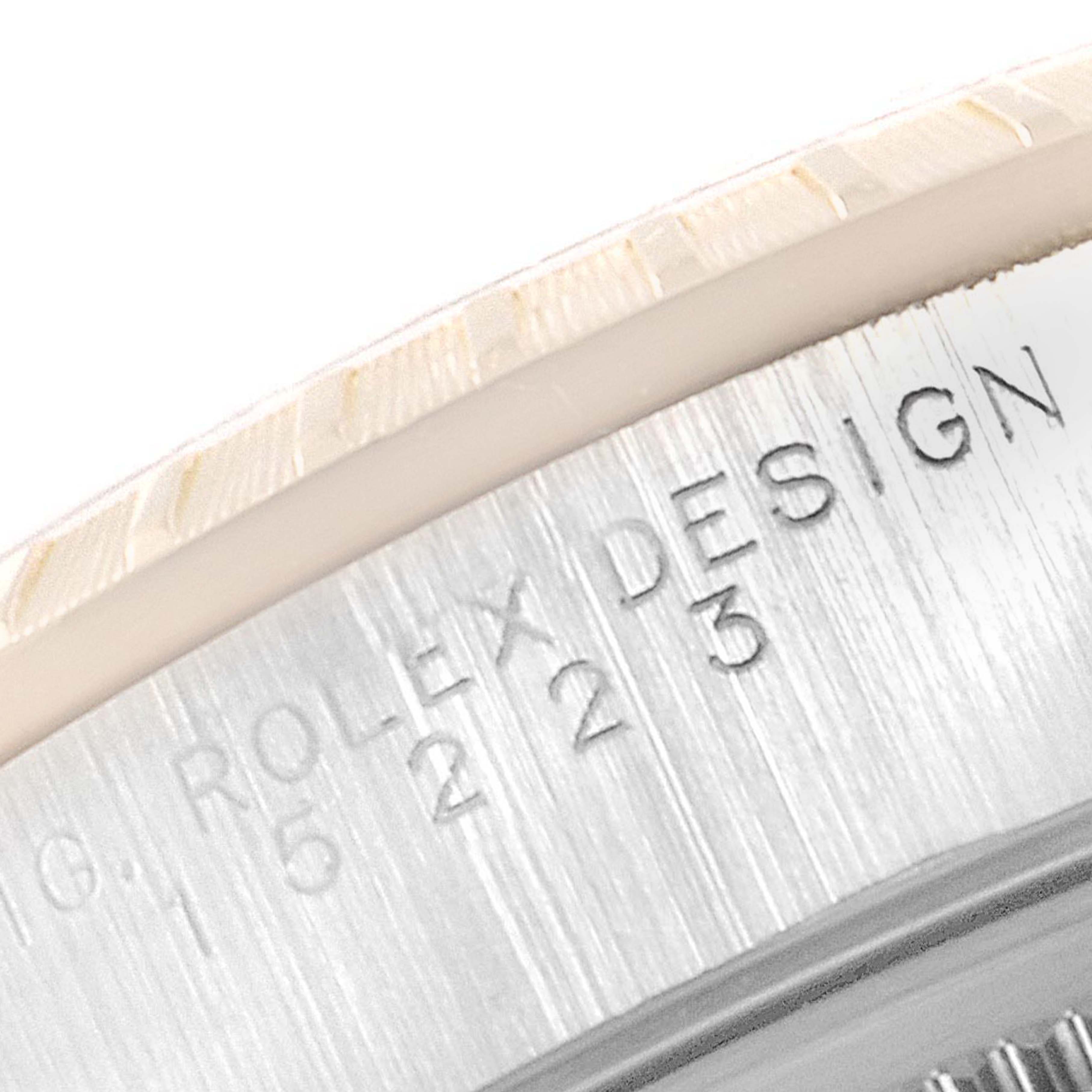 The image shows a close-up of the engraved side of the bezel and case of a Rolex Date 15223 Men's Steel and Gold (two tone) White Dial 15223 Men's Steel and Gold (two tone) White Dial watch.