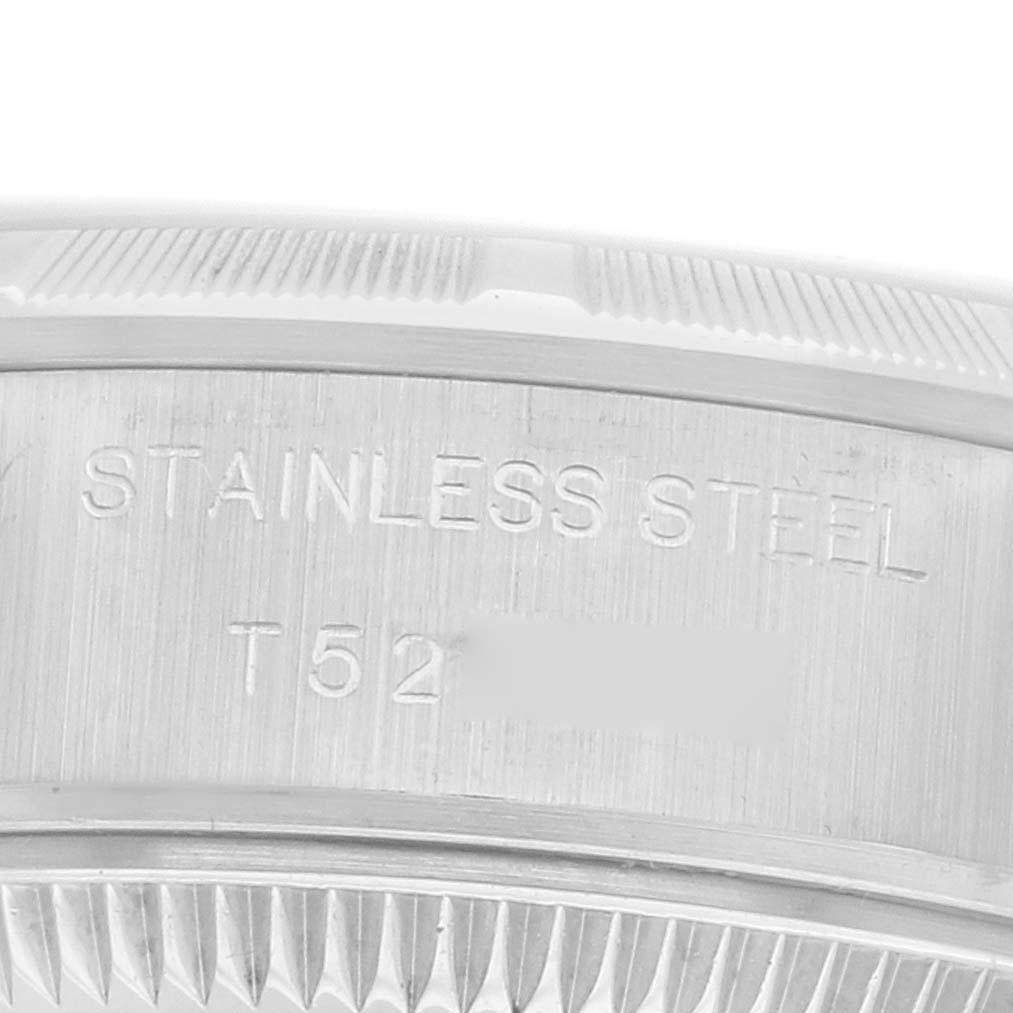 The image shows the side of a Rolex Date 69190 Women
s Stainless Steel Silver Dial model, highlighting the stainless steel case with engravings.