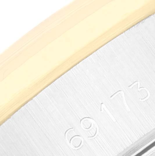 A close-up of the Rolex Datejust 69173 Women's Steel and Gold (two tone) Champagne Dial 69173 Women's Steel and Gold (two tone) Champagne Dial model, showing the serial number area with part of the metal case.