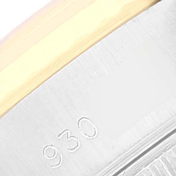 This image shows a close-up of the side of a Rolex Datejust 69173 Women's Steel and Gold (two tone) Champagne Dial 69173 Women's Steel and Gold (two tone) Champagne Dial watch, highlighting part of the bezel and case with an engraved number.