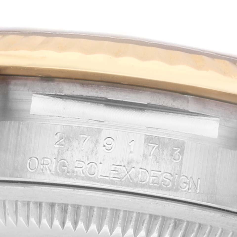 The image shows a close-up of the side of a Rolex Datejust 279173 Women's Steel and Gold (two tone) Champagne Dial case with engraved details.