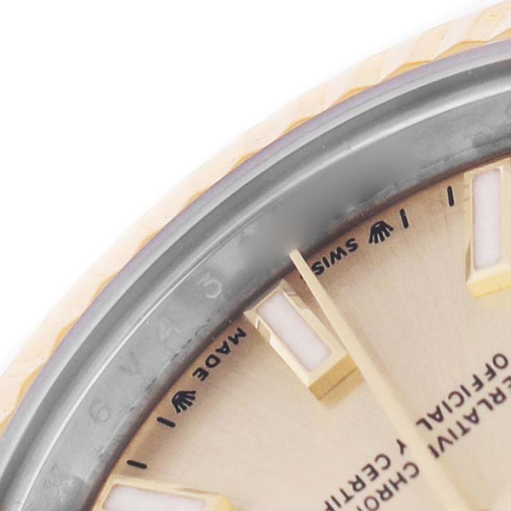 The image shows a close-up of the dial and part of the bezel of a Rolex Datejust 279173 Women's Steel and Gold (two tone) Champagne Dial, highlighting the hour markers and branding.