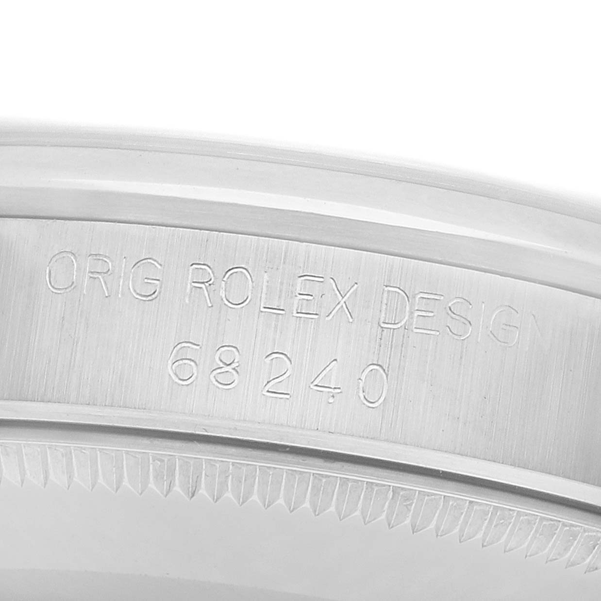 The image shows an engraved side view of a Rolex Datejust 68240 Women
s Stainless Steel Silver Dial watch, focusing on the serial number and design mark.