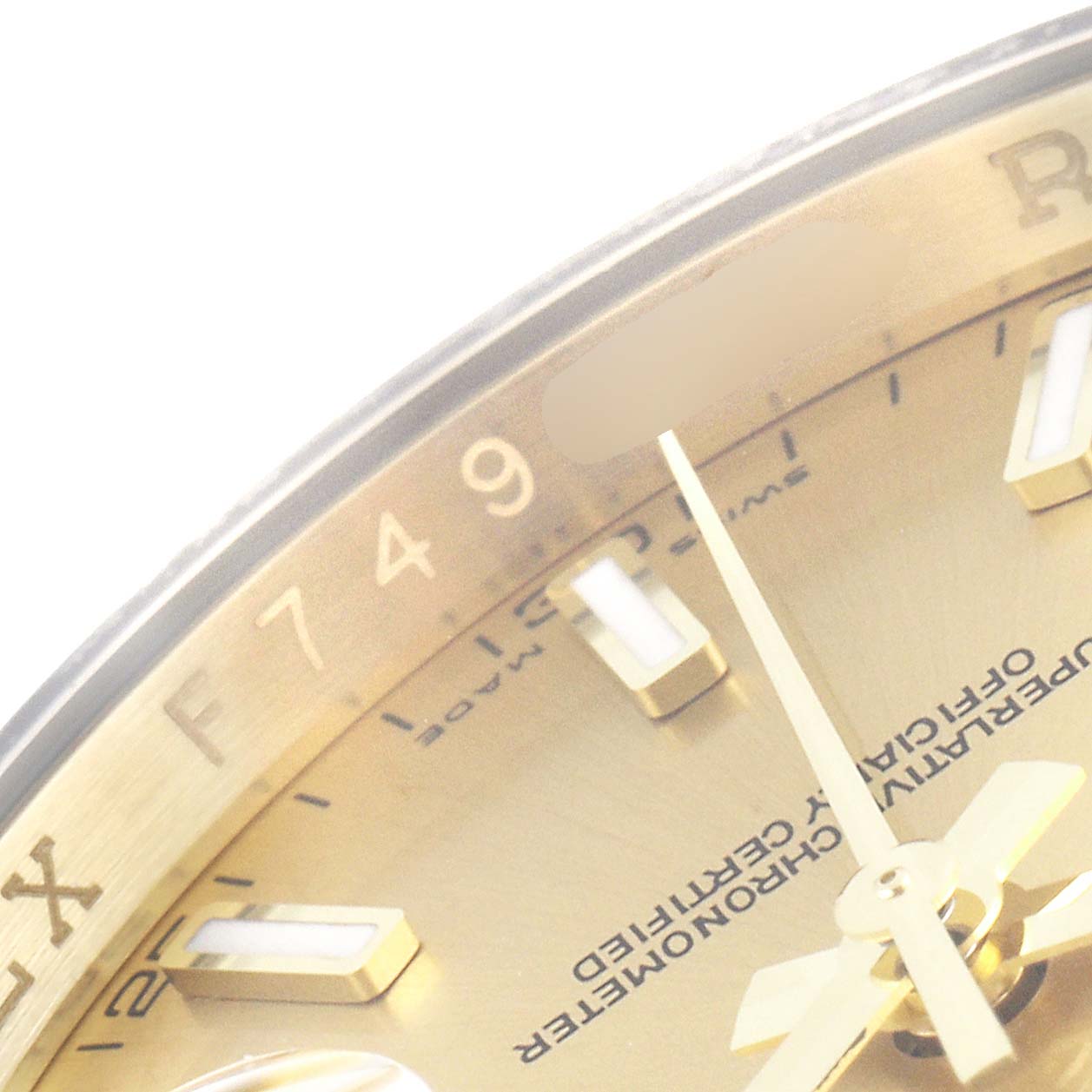 The image shows a close-up of the Rolex Datejust 116138 Men's Yellow Gold Champagne Dial 116138 Men's Yellow Gold Champagne Dial's gold dial with indices and part of the minute hand.