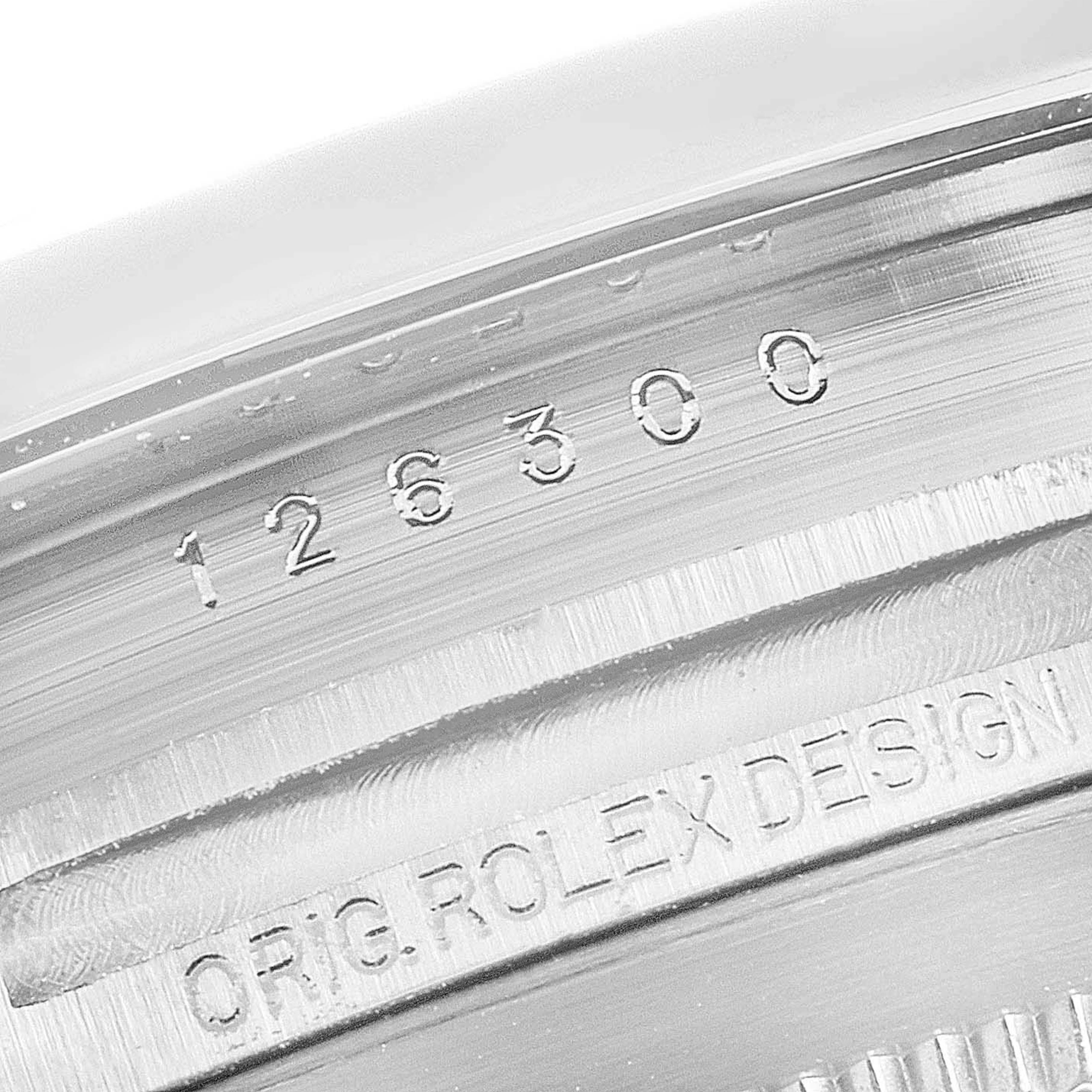 The image shows the engraved serial number and "ORIG. ROLEX DESIGN" on the inner bezel of a Rolex Datejust 41 126300 Men's Stainless Steel Black Dial 126300 Men's Stainless Steel Black Dial.