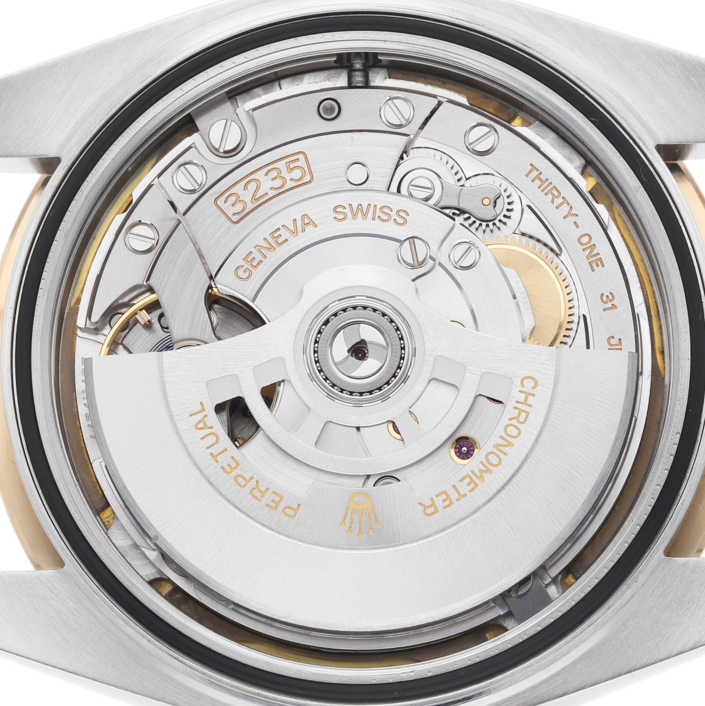 The image shows the back view of a Rolex Datejust 126333 Men
s Steel and Gold (two tone) White Dial, highlighting its movement and rotor mechanism.