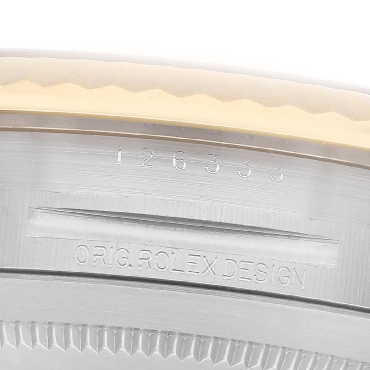 The image shows a close-up of the side of a Rolex Datejust 126333 Men
s Steel and Gold (two tone) White Dial
s case, detailing the engraved model number and "ORIG ROLEX DESIGN".