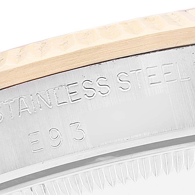 This image shows a close-up of the stainless steel bezel and engraved serial number on a Rolex Mid-Size 68273 Women
s Steel and Gold (two tone) Champagne Dial 68273 Women
s Steel and Gold (two tone) Champagne Dial watch.