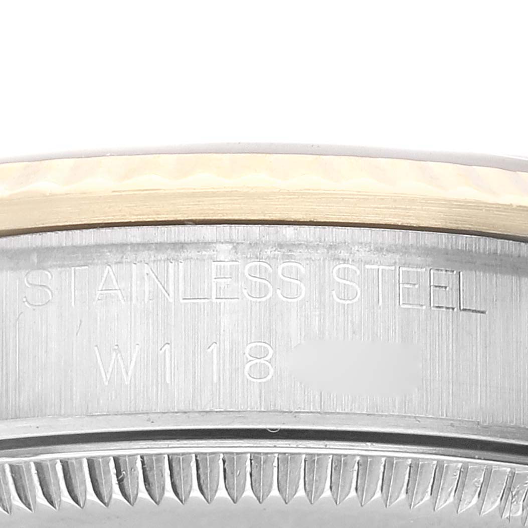 The image shows a close-up side view of the case of a Mid-Size Rolex watch, highlighting the stainless steel material and part of the engravings.