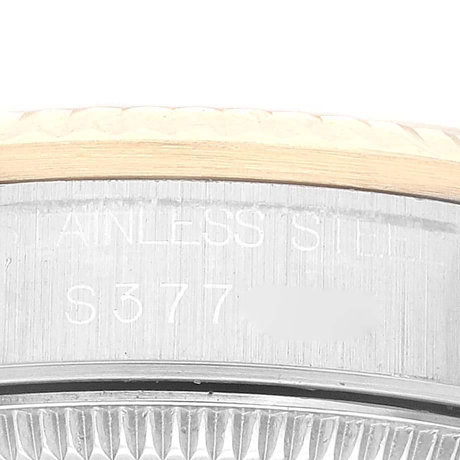 This close-up image shows the side engraving on the bezel of the Mid-Size Rolex watch, with the words "STAINLESS STEEL" visible.
