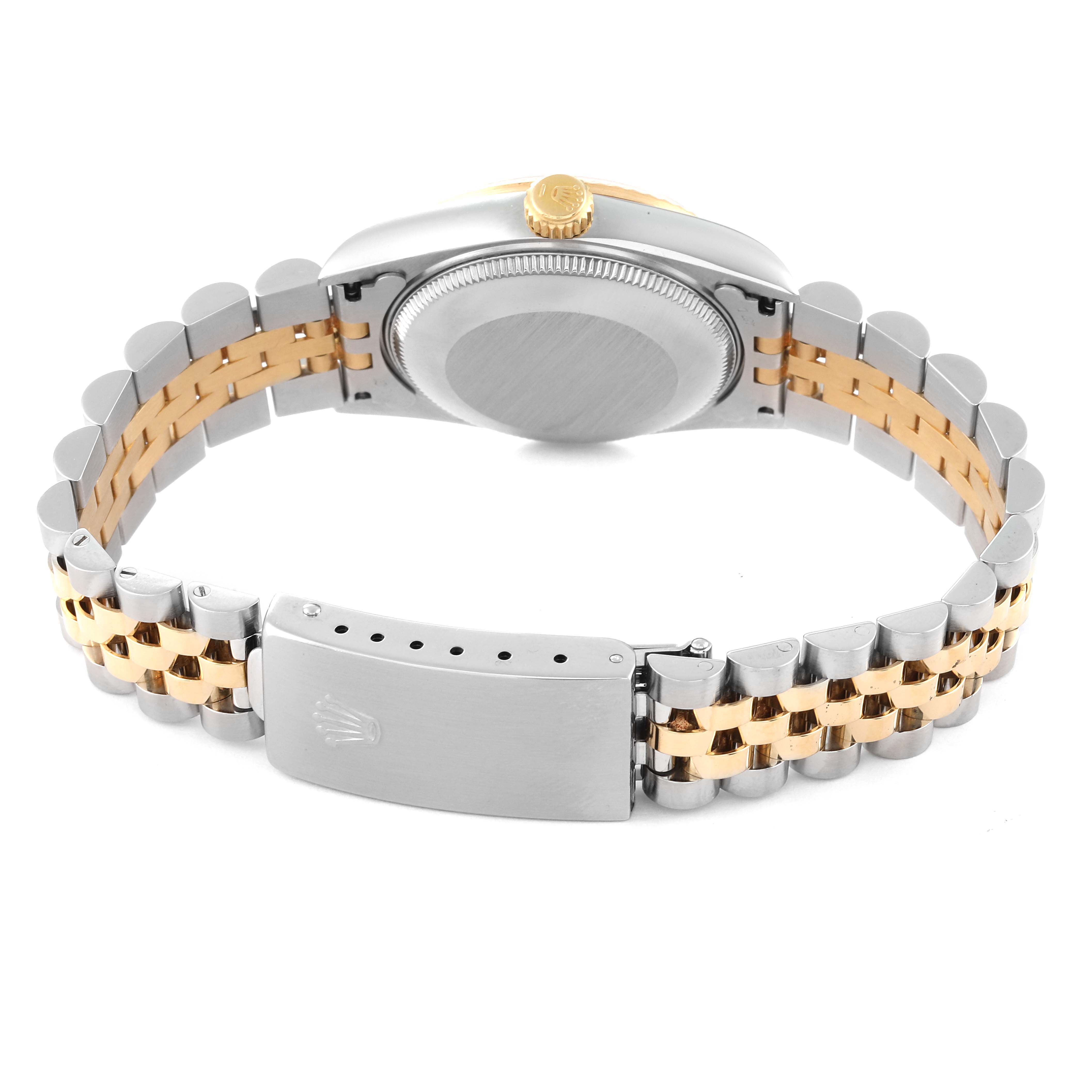 The image shows the back of a Rolex Mid-Size 68273 Women's Steel and Gold (two tone) Champagne Dial 68273 Women's Steel and Gold (two tone) Champagne Dial watch, highlighting its bi-metal bracelet and clasp, along with the watch's crown and case back.