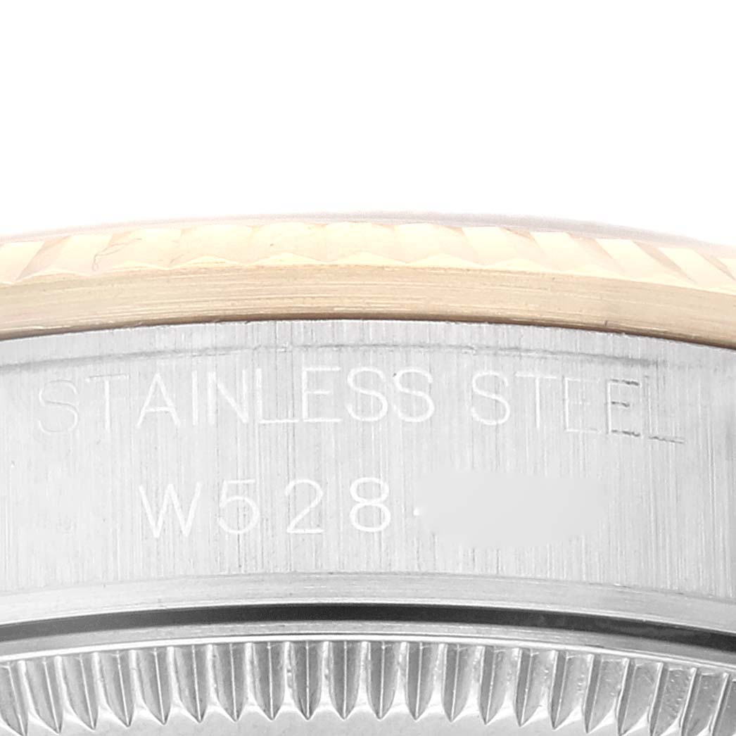This close-up image shows the side view of a stainless steel bezel and case back, with engravings, on a Rolex Mid-Size 68273 Women's Steel and Gold (two tone) Champagne Dial 68273 Women's Steel and Gold (two tone) Champagne Dial model watch.