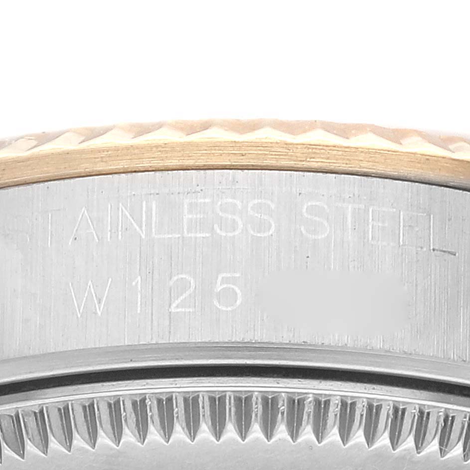 The image shows the edge and engraving details on the case back of a Rolex Mid-Size 68273 Women's Steel and Gold (two tone) White Dial 68273 Women's Steel and Gold (two tone) White Dial watch, highlighting the stainless steel material.