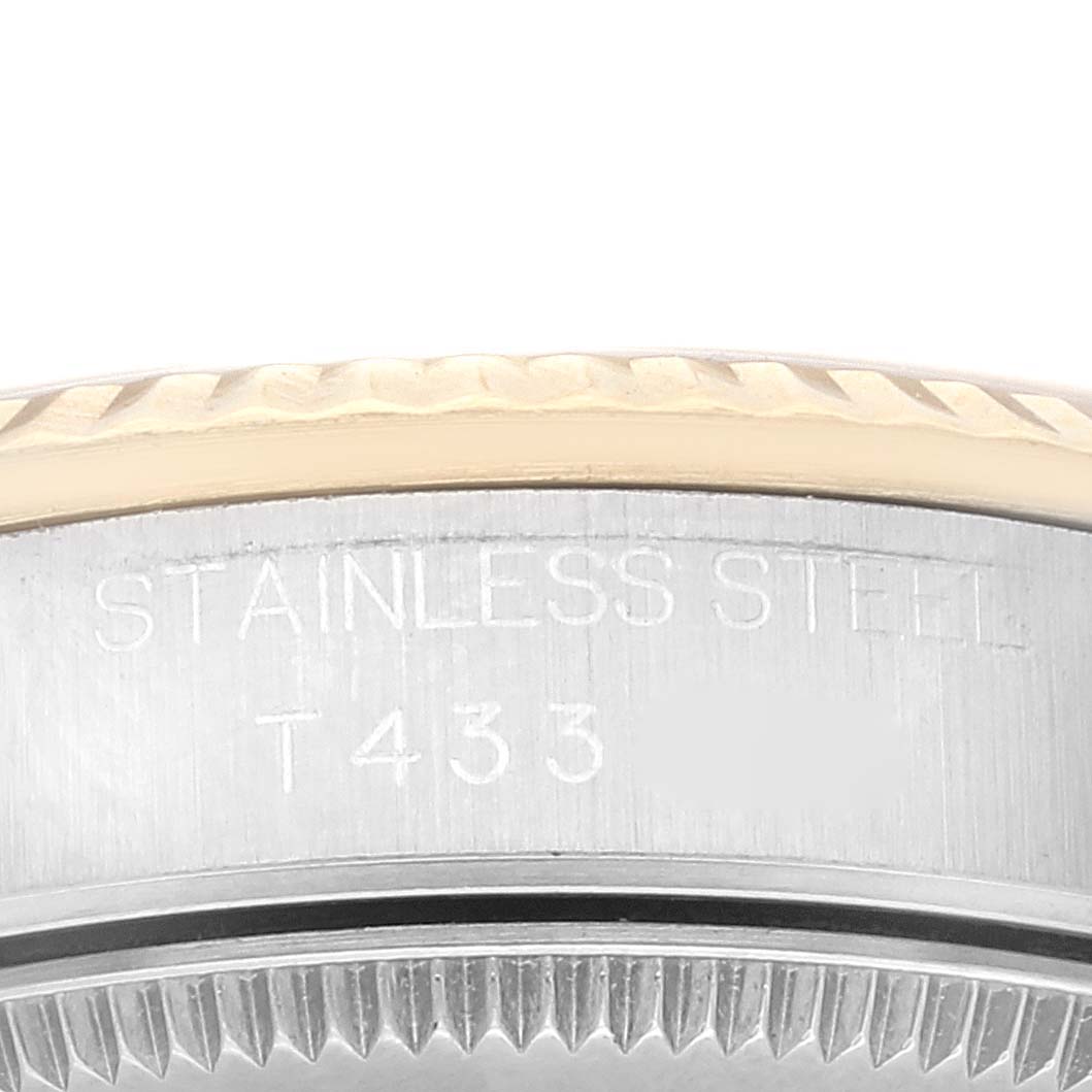 The image shows a close-up of the side of a Rolex Mid-Size 68273 Women's Steel and Gold (two tone) Champagne Dial 68273 Women's Steel and Gold (two tone) Champagne Dial watch, focusing on the engraving "STAINLESS STEEL" and "T433."
