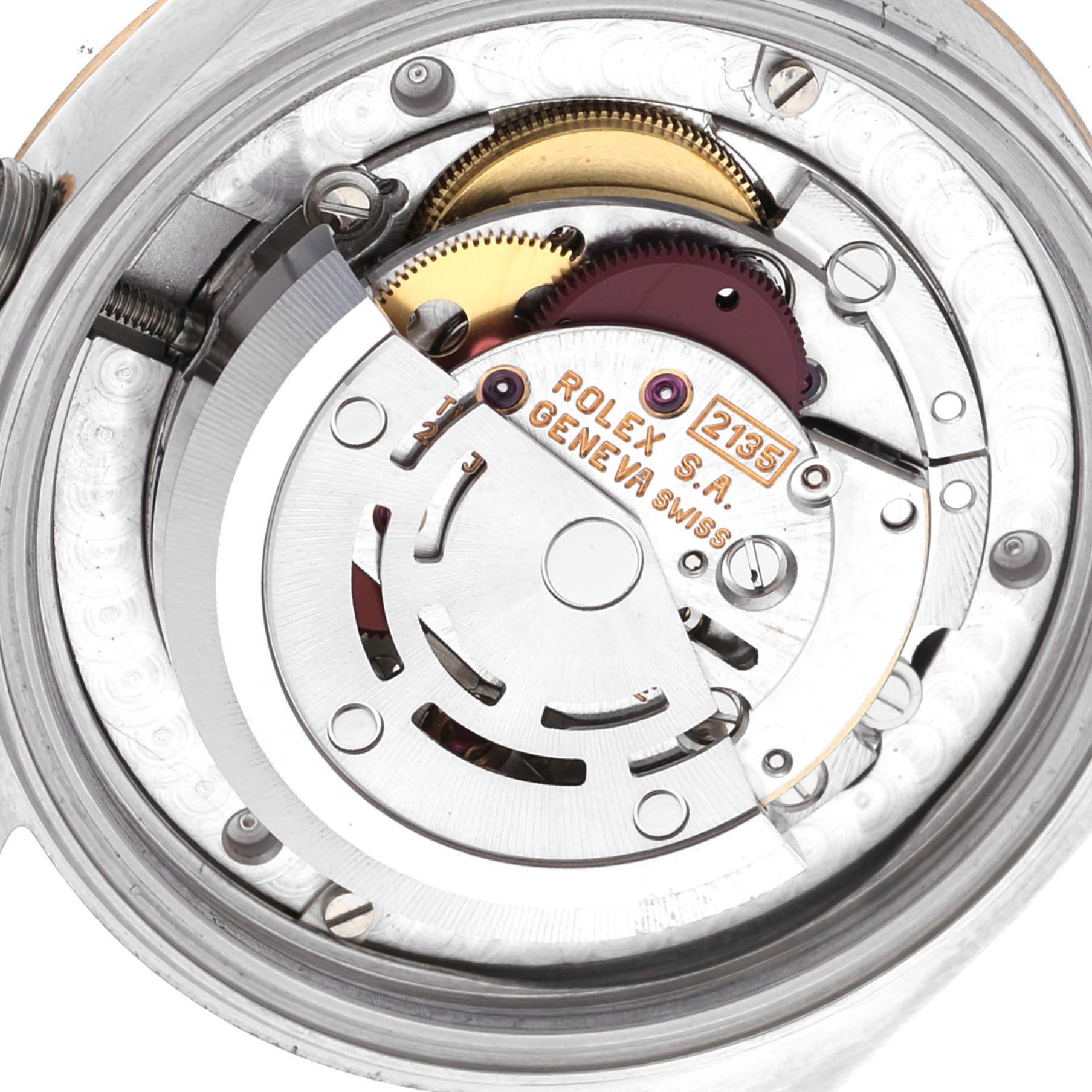 The image displays the internal mechanics of a Rolex Mid-Size 68273 Women's Steel and Gold (two tone) Champagne Dial 68273 Women's Steel and Gold (two tone) Champagne Dial model, highlighting gears and the rotor from a close-up angle.