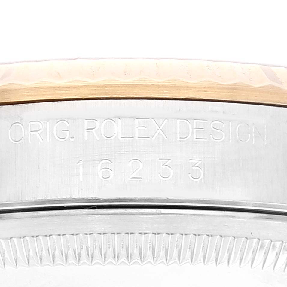 This image shows a close-up of the side of a Rolex Datejust 16233 Men's Steel and Gold (two tone)  16233 Men's Steel and Gold (two tone) , revealing the model number 16233 and the engraving "ORIG. ROLEX DESIGN."