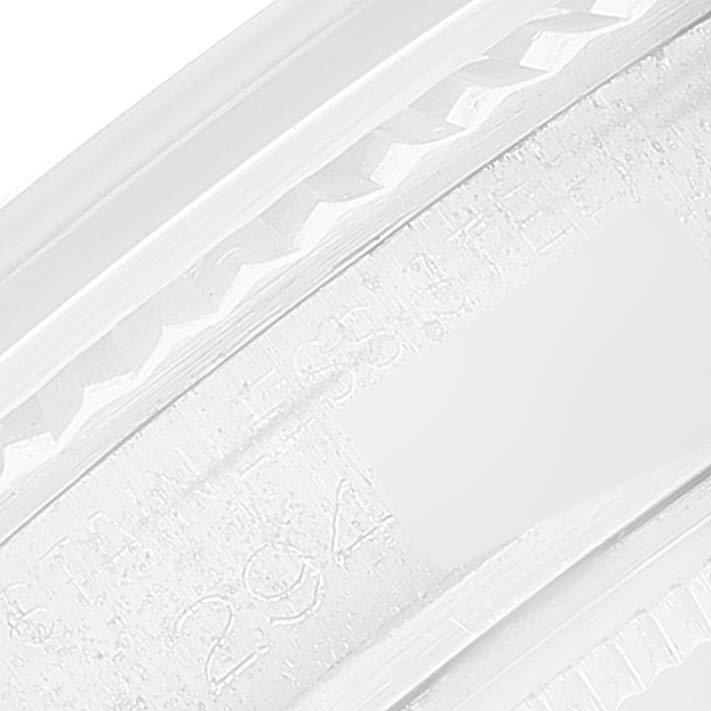 This image shows a close-up of the edge and engravings on the band of a Vintage Collection model by Rolex.